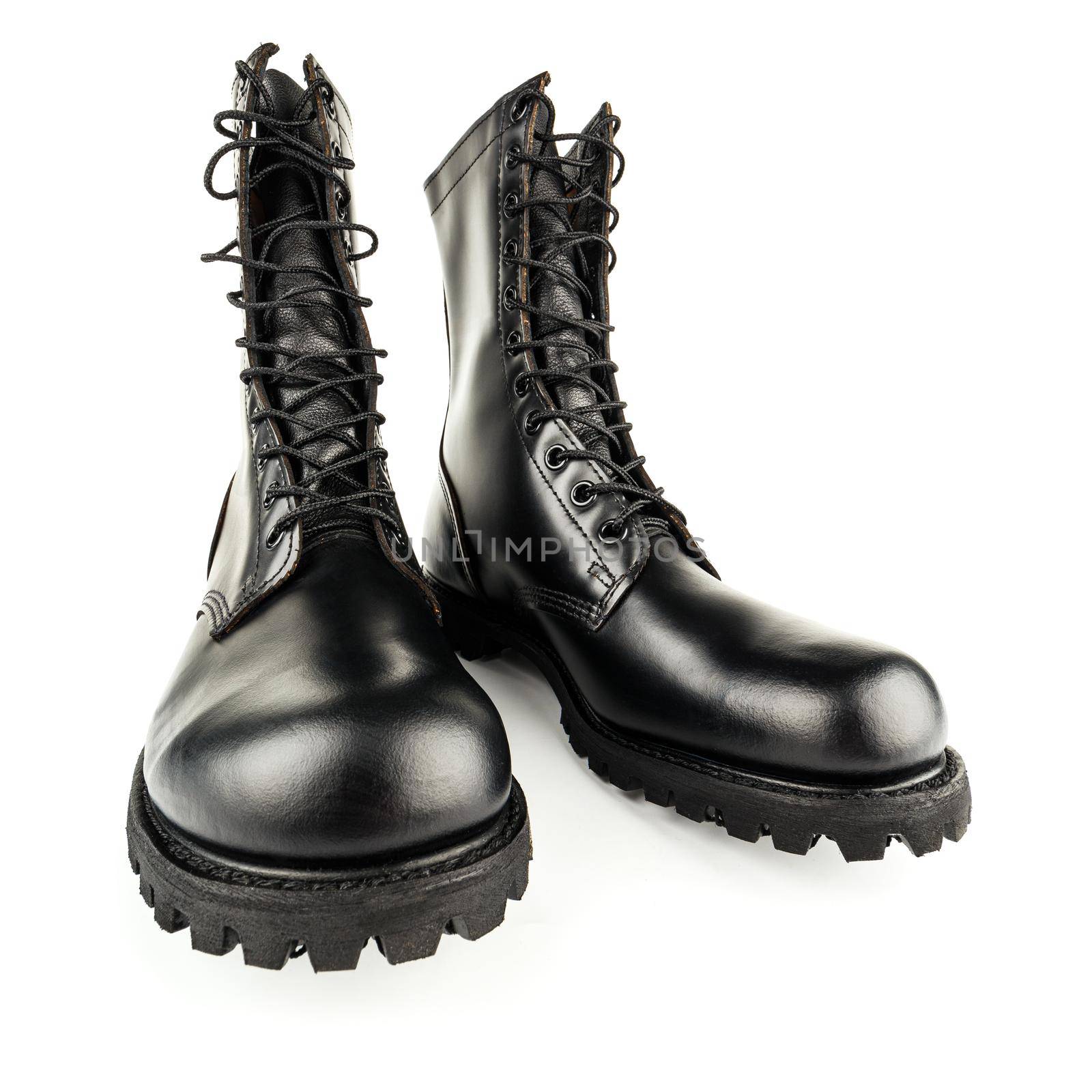 three quarter front view on pair of black leather 10-inch new black military combat boots, isolated on white background by z1b