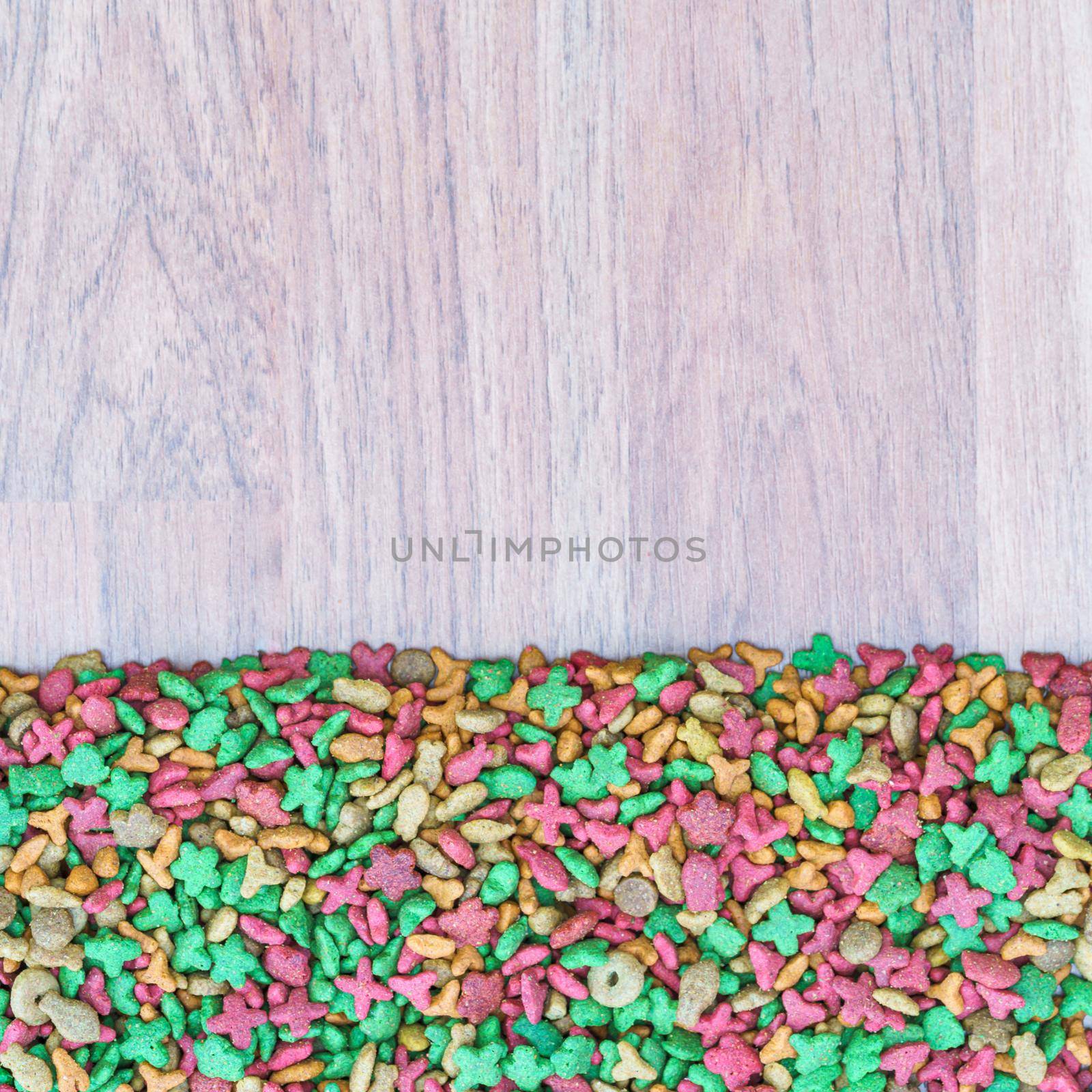 Top view dry cat food on wooden background with copy space
