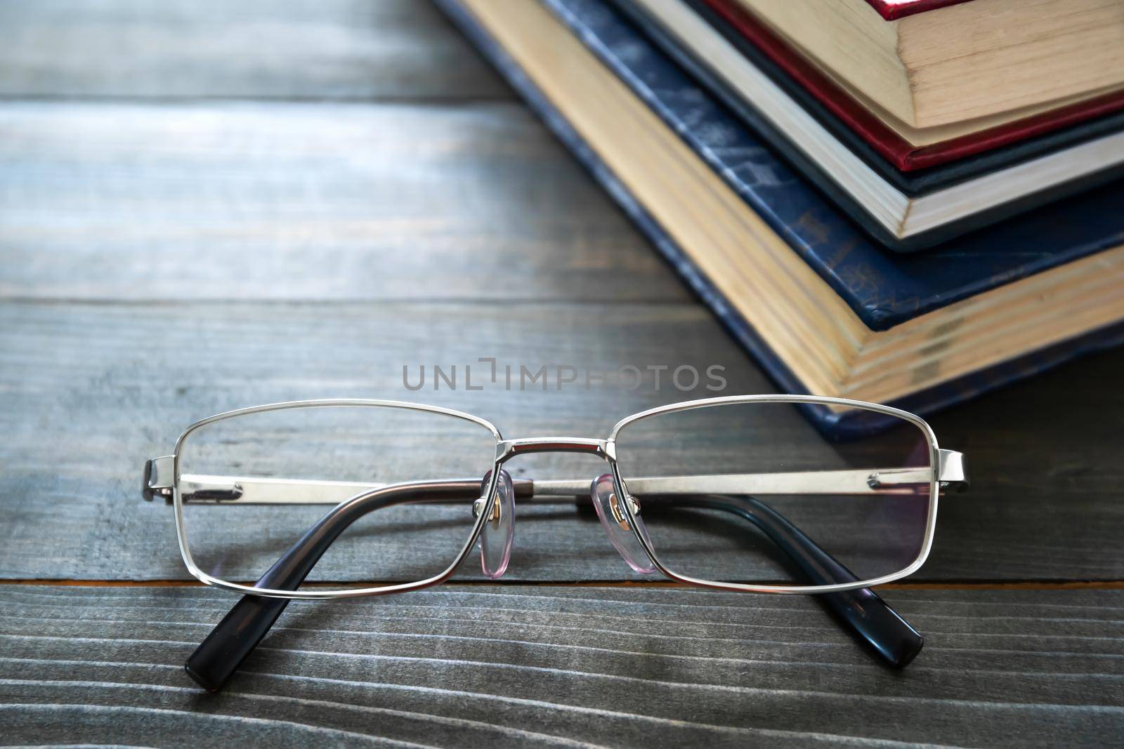 Glasses and stack of hardcover books by stoonn