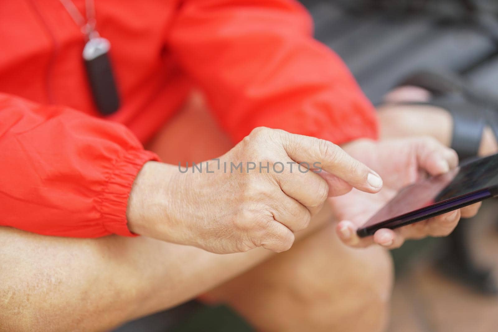 asian old elder senior man elderly male using mobile smart phone cellphone outdoor. mature retirement lifestyle