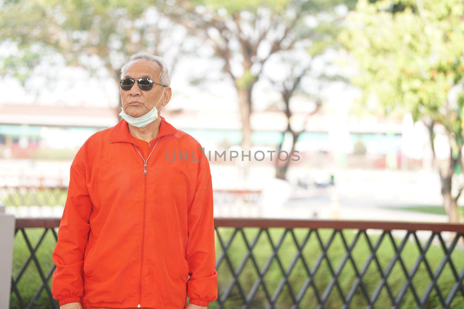 asian old elderly male elder man resting relaxing in garden. senior leisure lifestyle