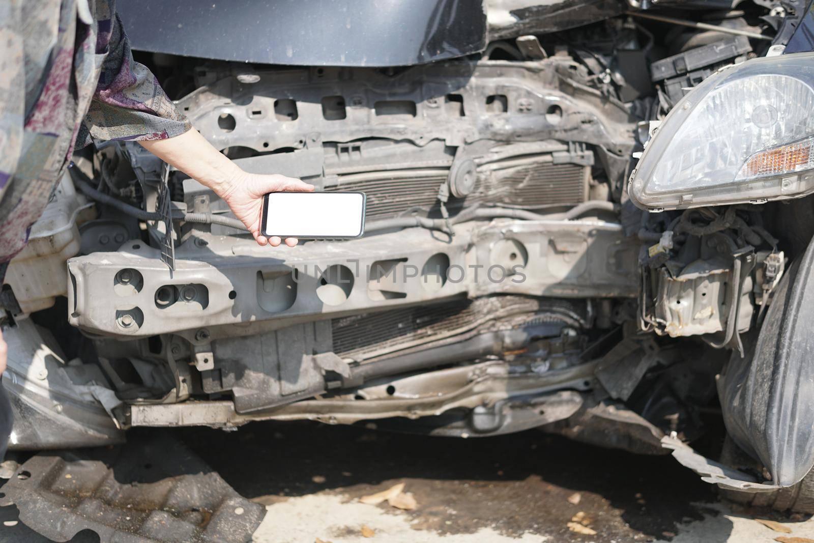 hand take photo of crashed damaged broken car. automobile crash collision accident