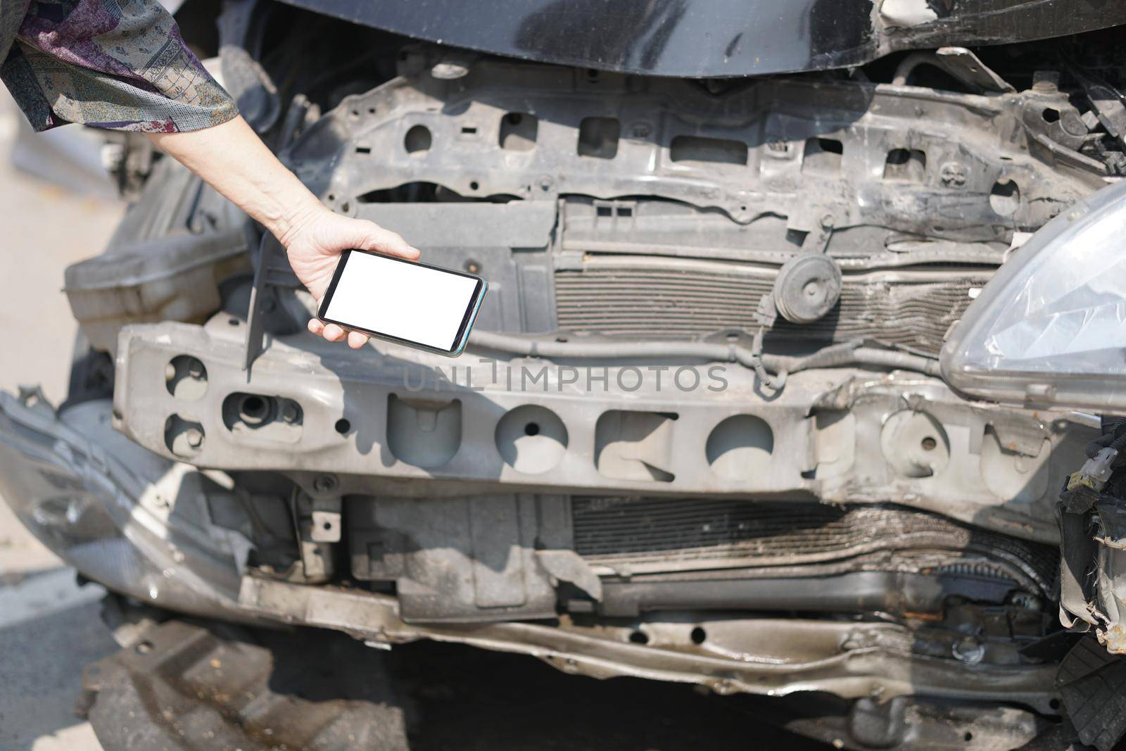 hand take photo of crashed damaged broken car. automobile crash collision accident