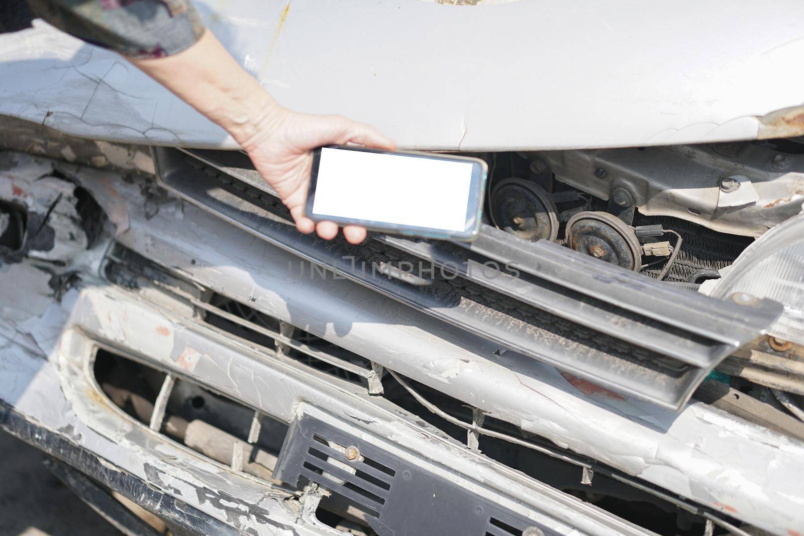 hand take photo of crashed damaged broken car. automobile crash collision accident