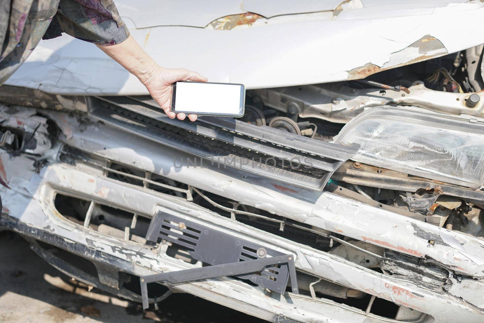 hand take photo of crashed damaged broken car. automobile crash collision accident