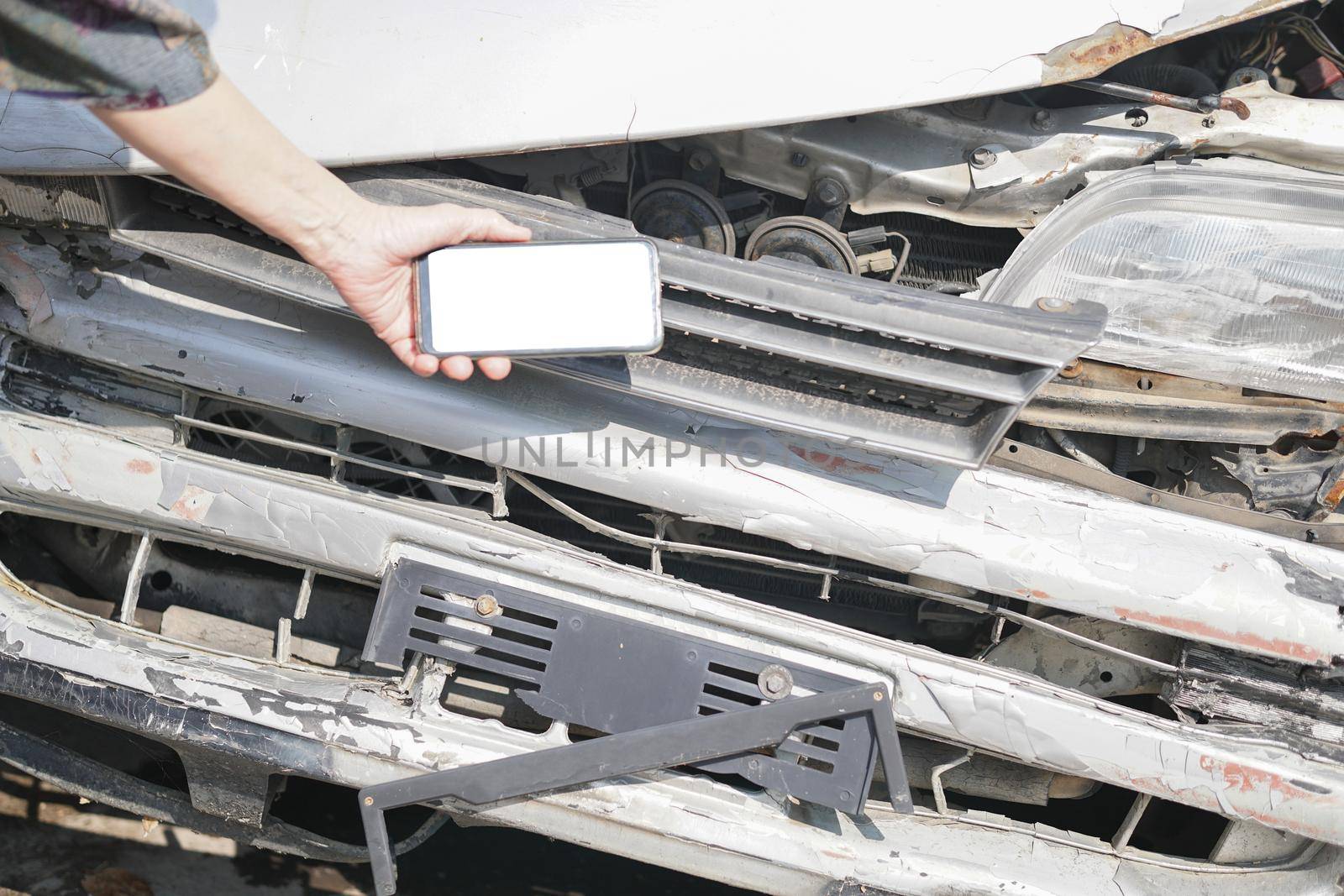 hand take photo of crashed damaged broken car. automobile crash collision accident