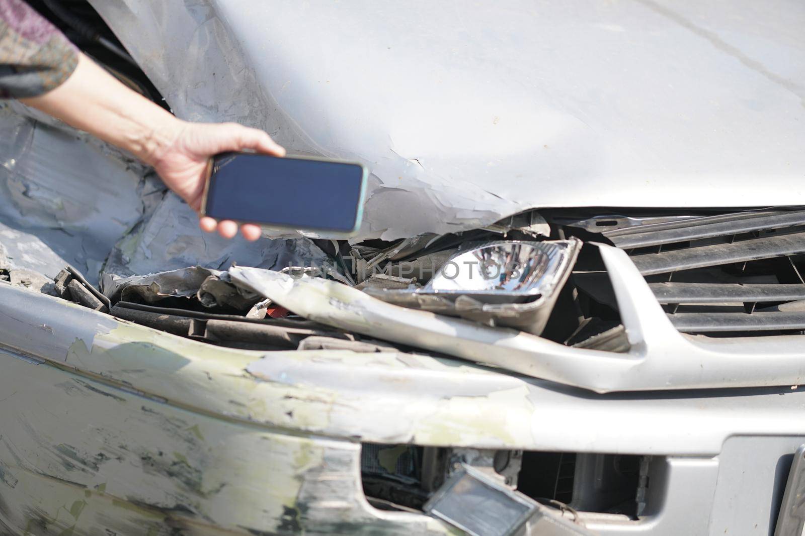 hand take photo of crashed damaged broken car. automobile crash collision accident