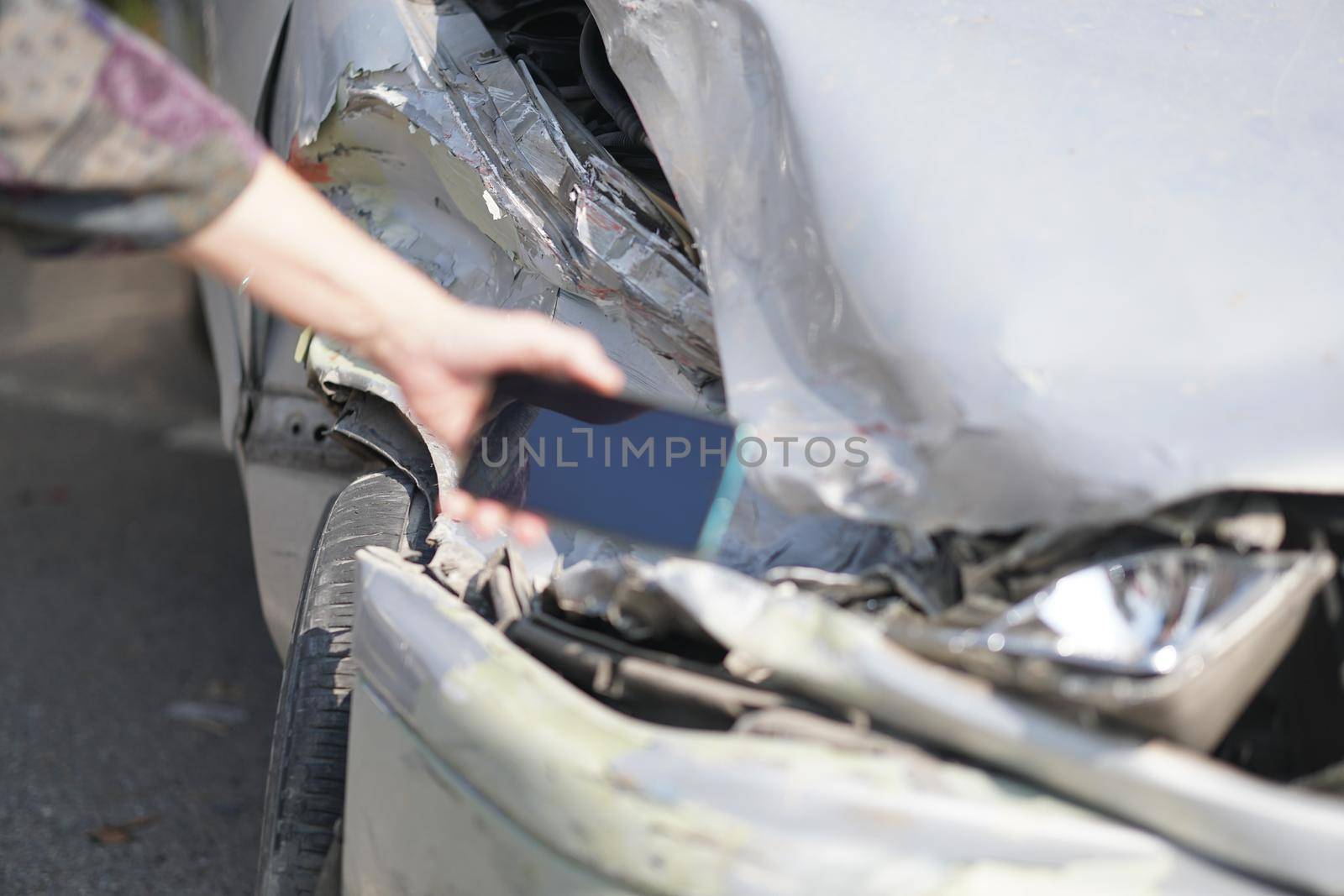 hand take photo of crashed damaged broken car. automobile crash collision accident