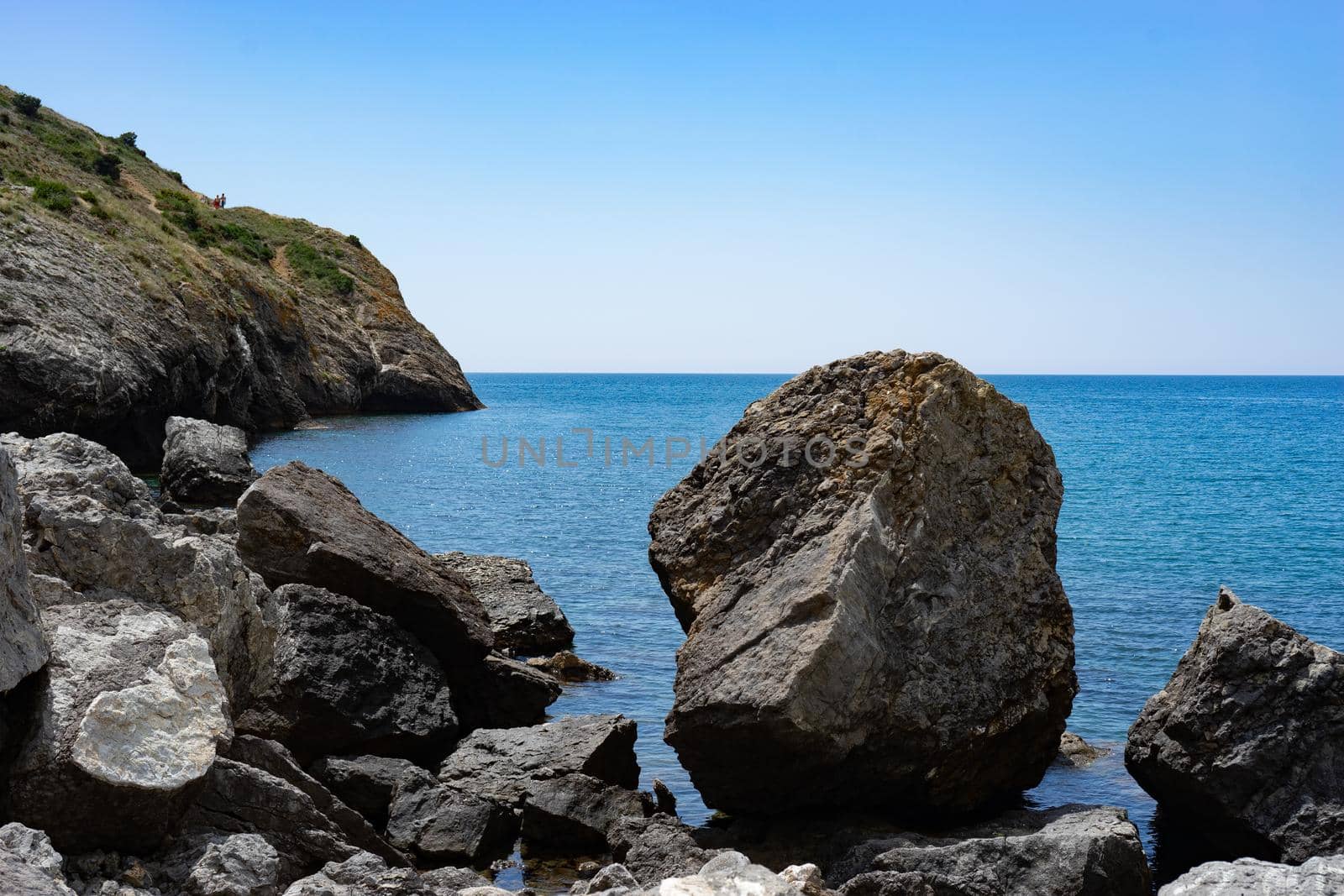 Seascape with rocks on the background of water. Sudak, Crimea