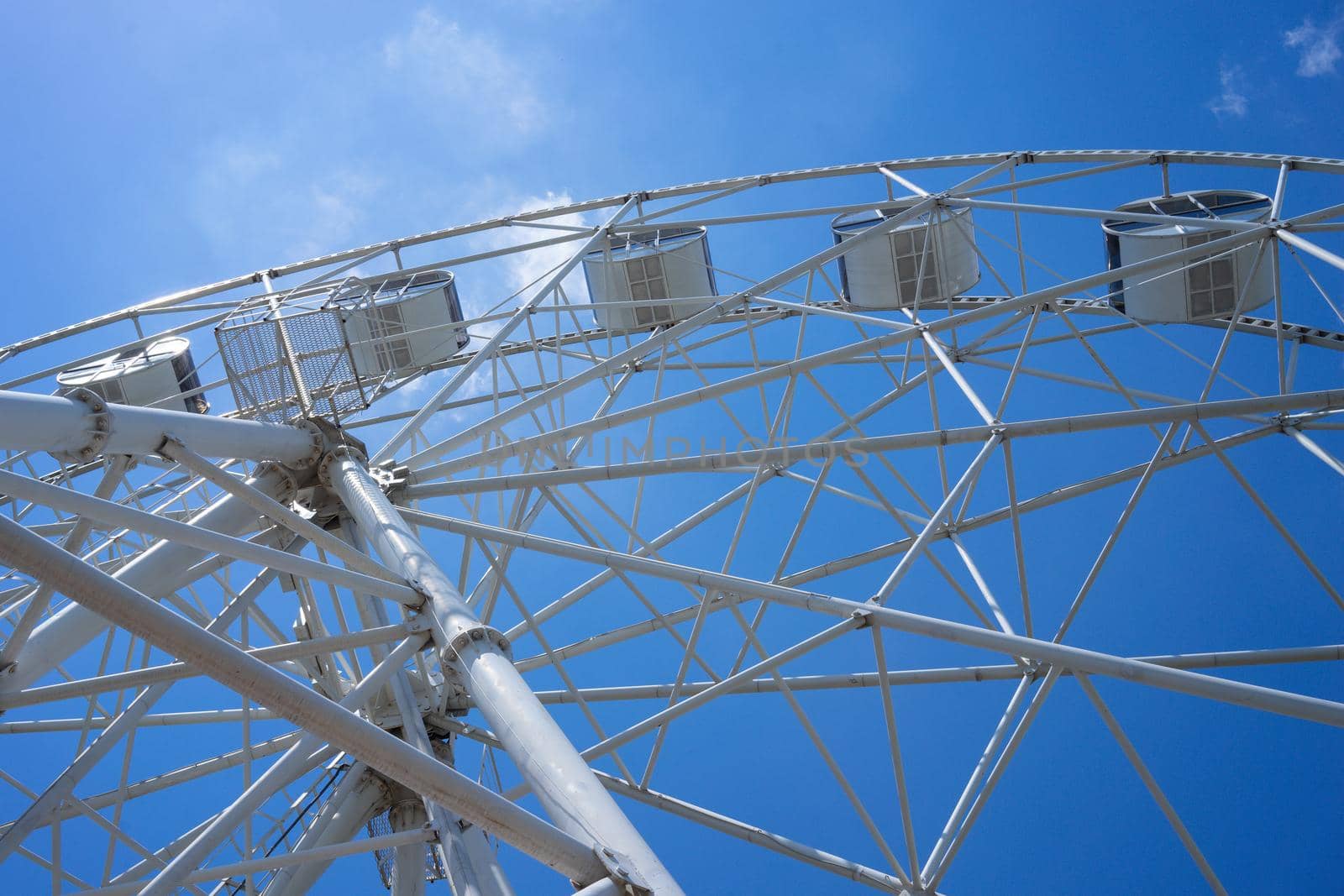 Beautiful and modern Ferris wheel on blue sky background. Evpatoria, Crimea
