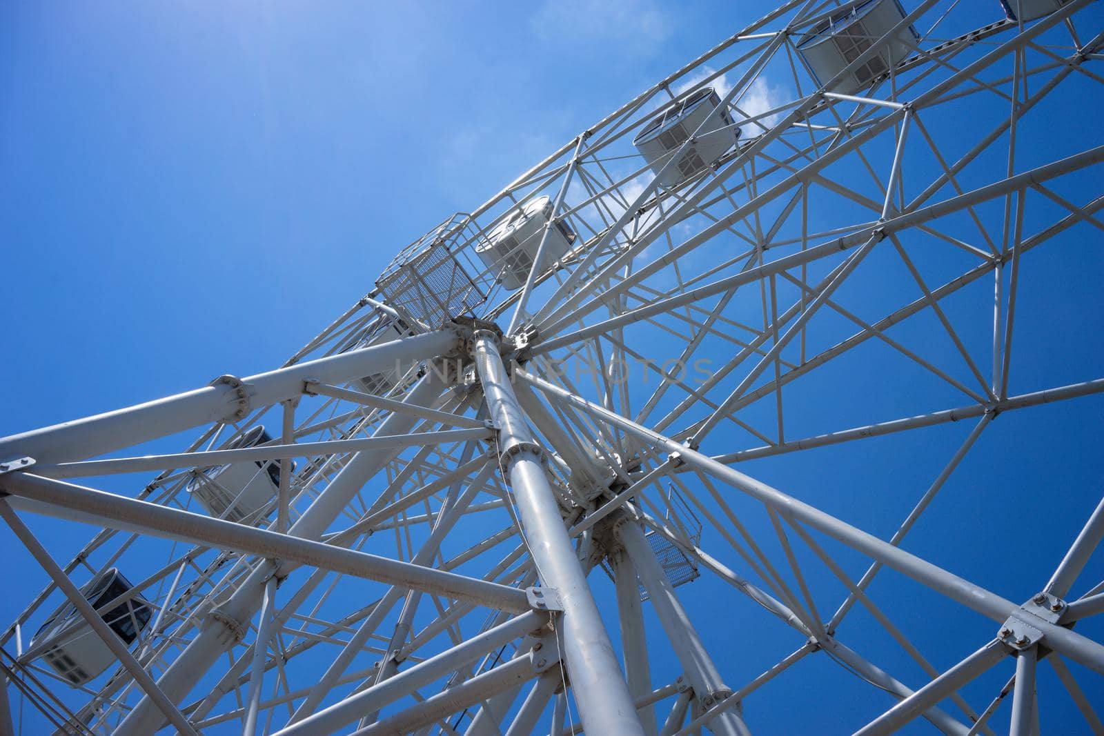 Beautiful and modern Ferris wheel on blue sky background. Evpatoria, Crimea