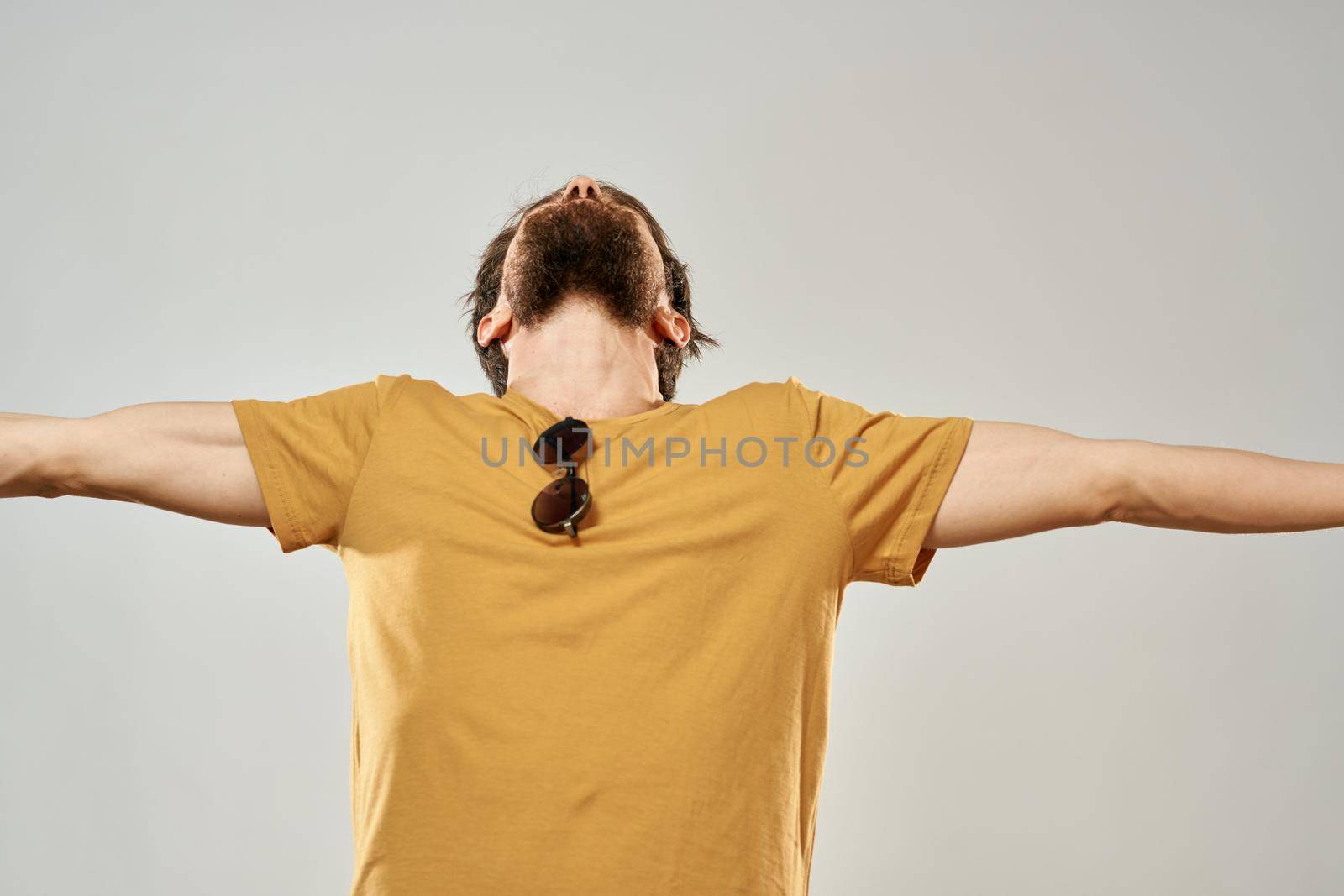 Bearded man in a yellow t-shirt dark glasses emotions lifestyle light background fashion by SHOTPRIME