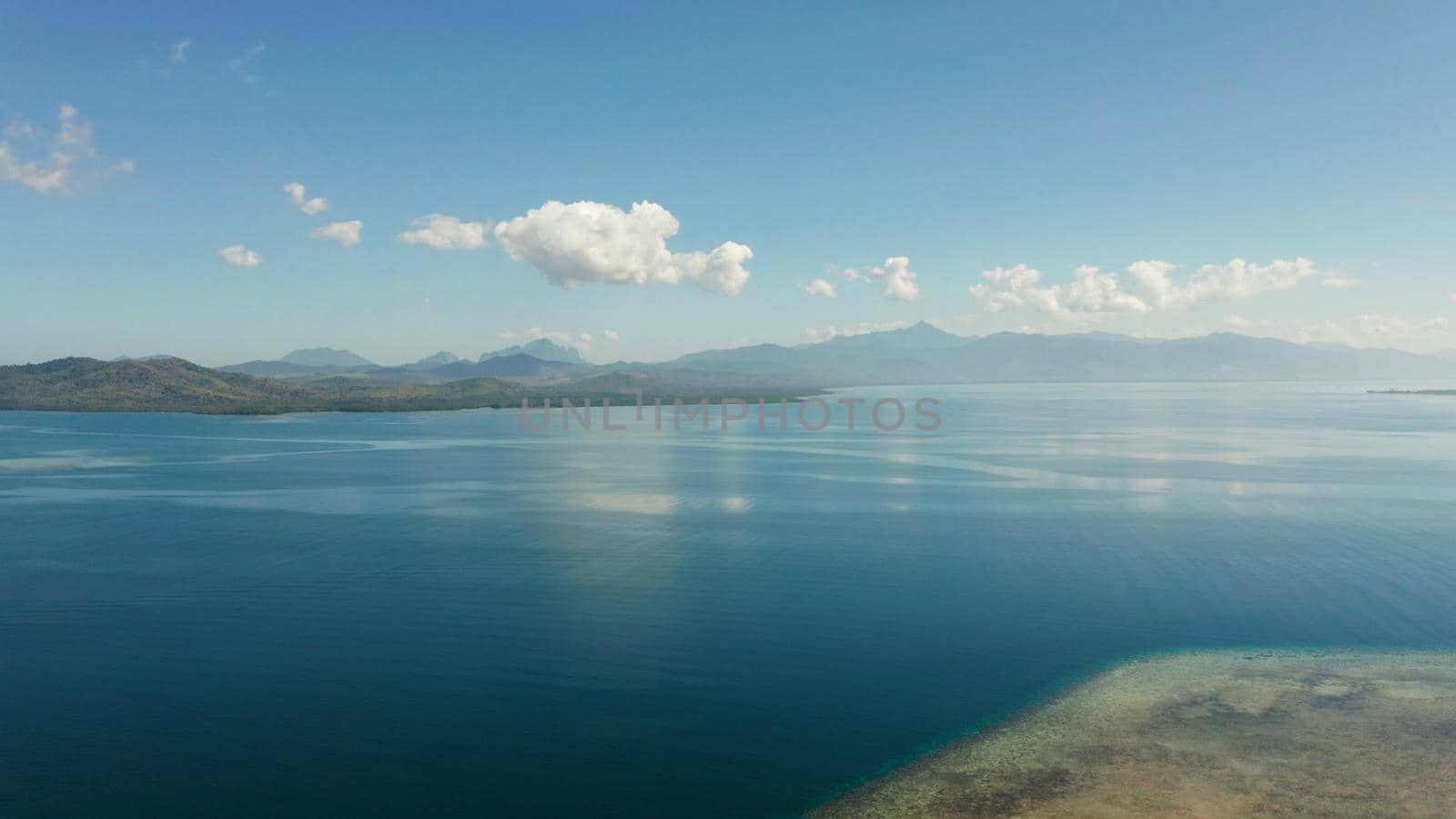 aerial view Seascape: Honda bay with boats and sea with blue water and tropical islands covered with forest. Puerto princesa, Palawan, Philippines.