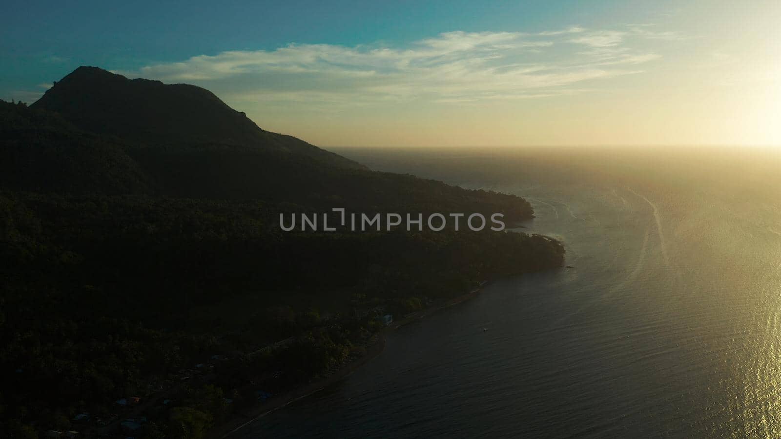 Sunset on tropical island with coast and sea, aerial view. Seascape: Ocean and sky.Philippines, Camiguin.