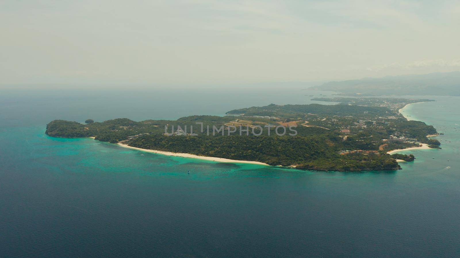 Costline of the tropical island of Boracay with sandy beaches and hotels from above. Summer and travel vacation concept. Philippines.