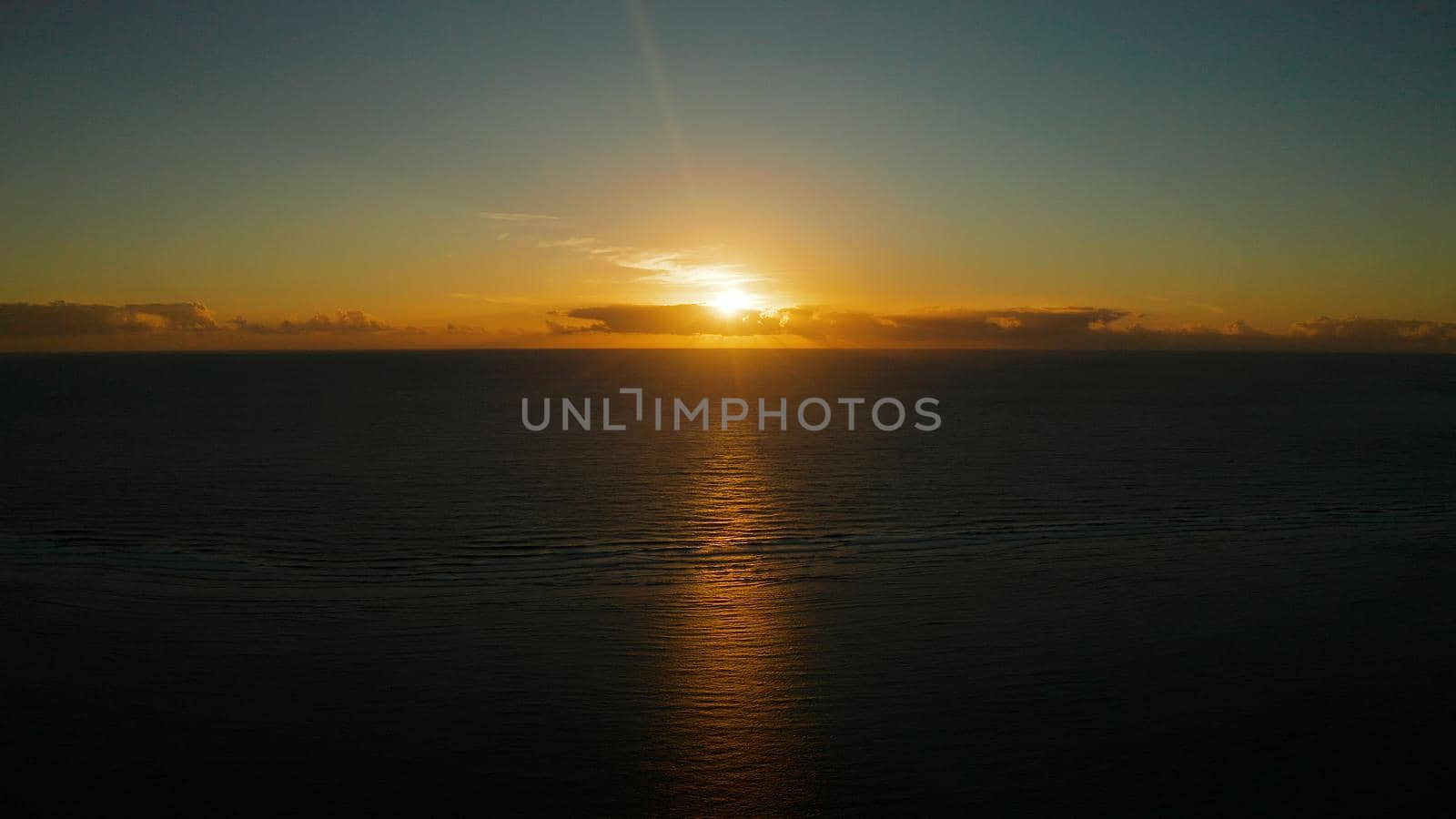 Sunrise above the sea surface with waves, aerial view. Sunrise over ocean. Philippines