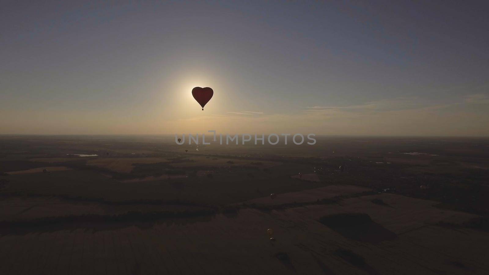 Hot air balloon shape of a heart in the blue sky. Aerostat, Airship. Red balloon.