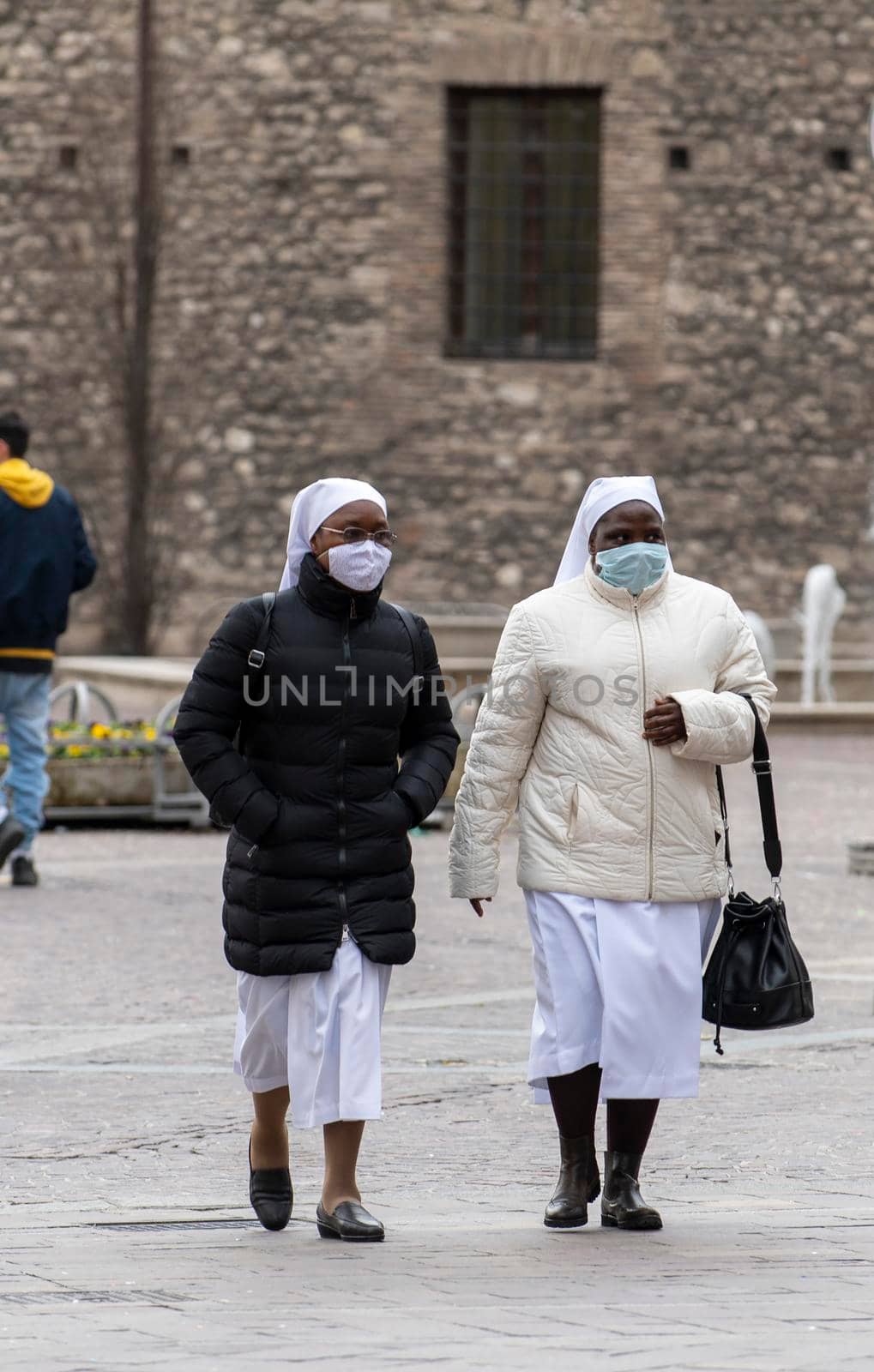 terni ,italy february 12 2021:nuns out for a walk in the center of terni