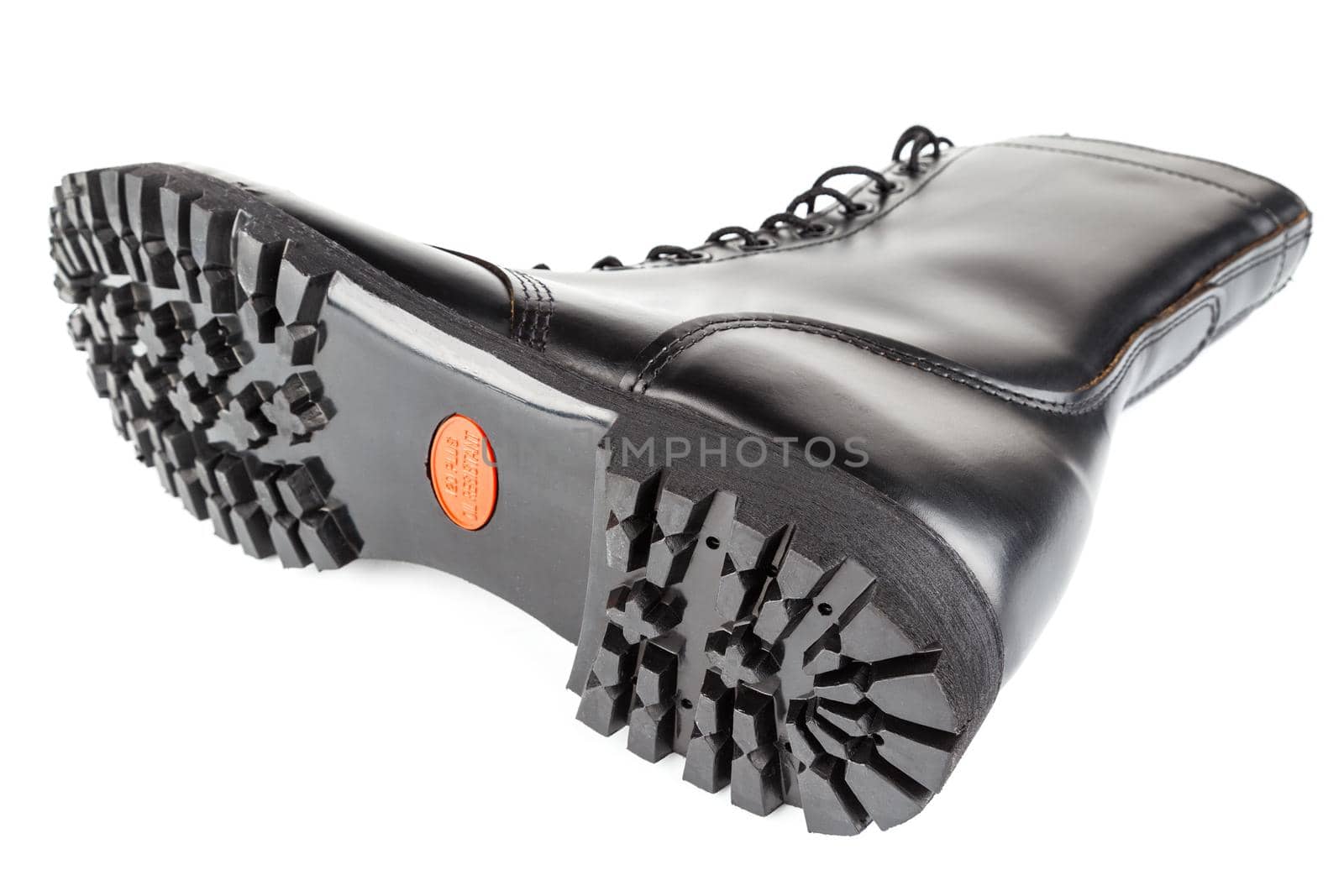 close-up wide angle view of new boot mini lugs black rubber outsole with 120 plus oil resistance grade , isolated on white background