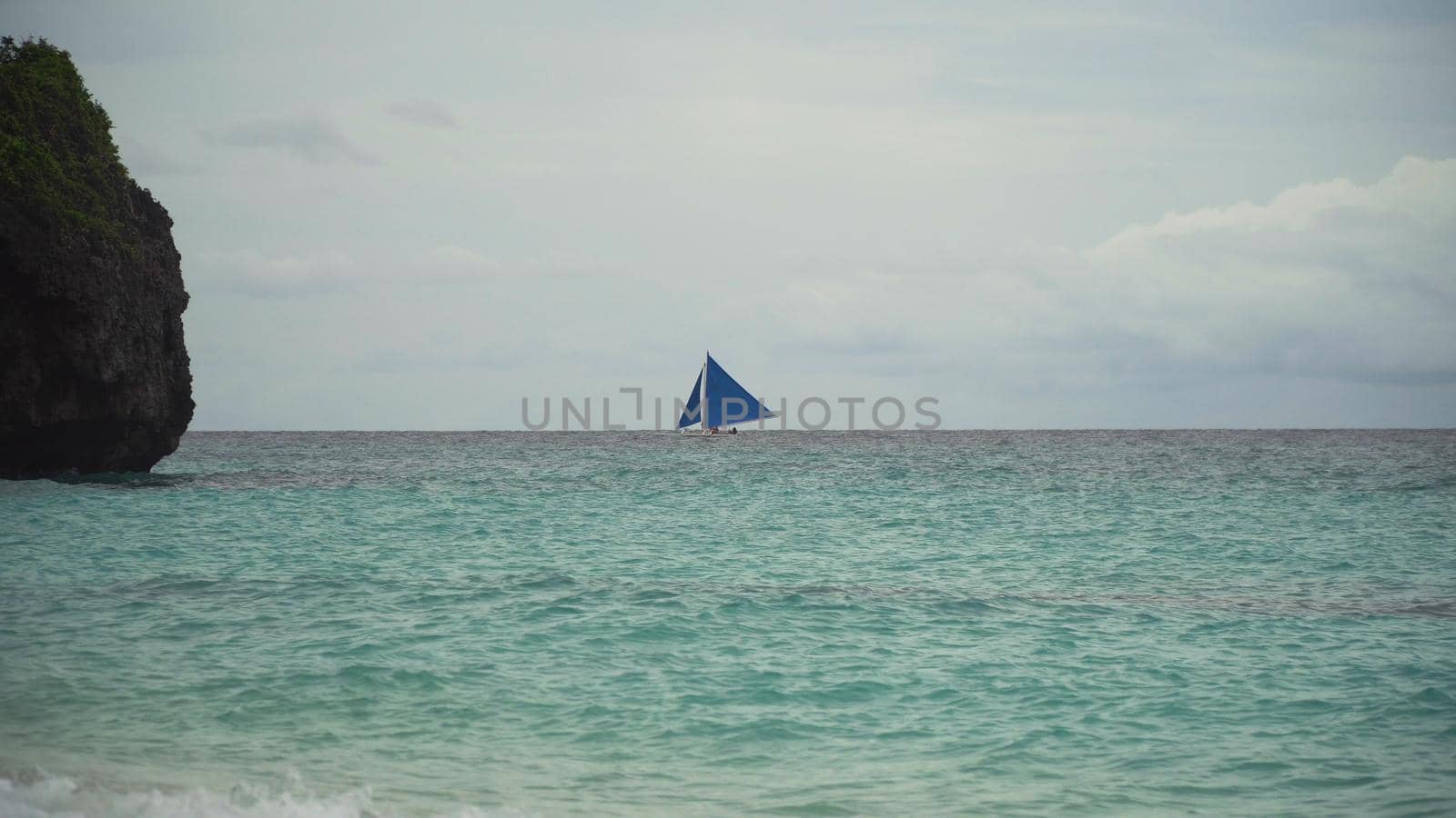 Sailing boat on sea. Sailing ship yachts with blue sails in the ocean. Sailing ship yachts in the sea. Philippines, Boracay. Travel concept.