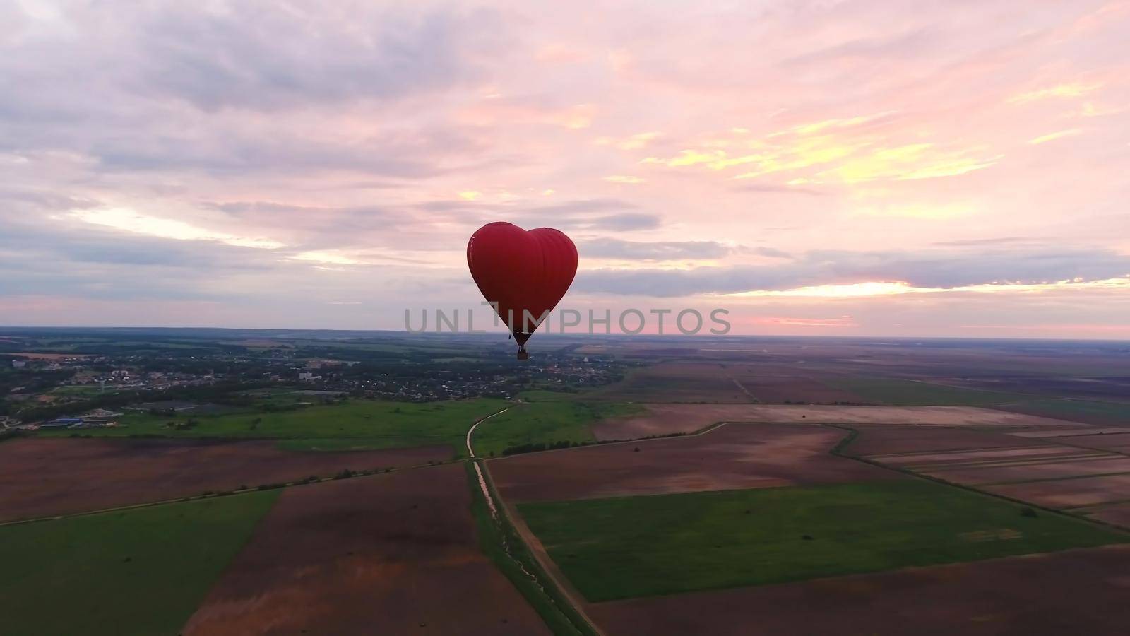 Hot air balloon shape of a heart in the blue sky. Aerostat, Airship. Red balloon.