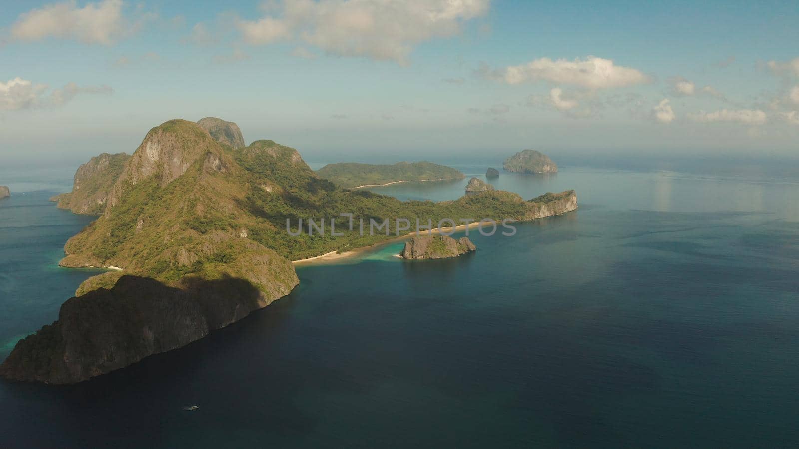 Cove with tropical rocky islands covered with rainforest, sea with blue water, aerial view. El nido, Philippines, Palawan. Tropical Mountain Range