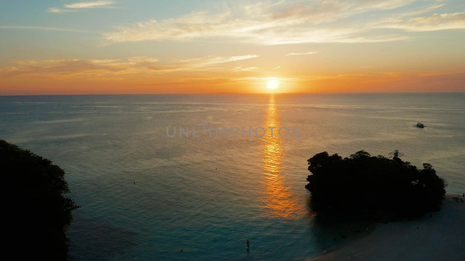Colorful bright clouds during sunset over the sea, aerial view. Sunset over ocean. Boracay, Philippines. Seascape, Summer and travel vacation concept