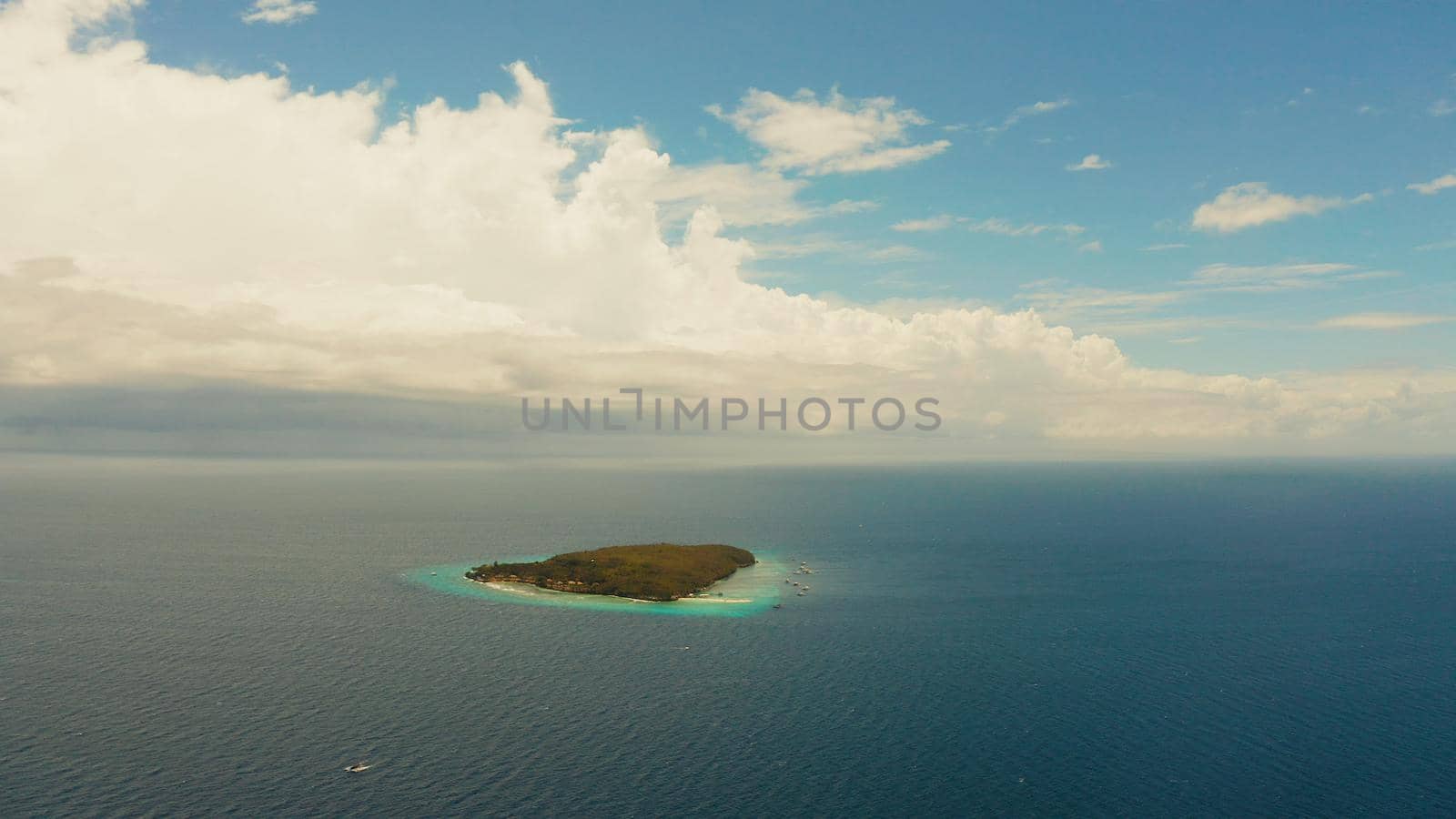 Tropical island with sandy beach in the blue sea, aerial view. Small island with sandy beach. Summer and travel vacation concept, Sumilon island, Philippines.
