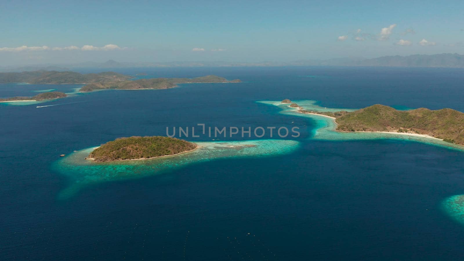 aerial drone tropical islands with blue lagoons, coral reef and sandy beach. Palawan, Philippines. Islands of the Malayan archipelago with turquoise lagoons.