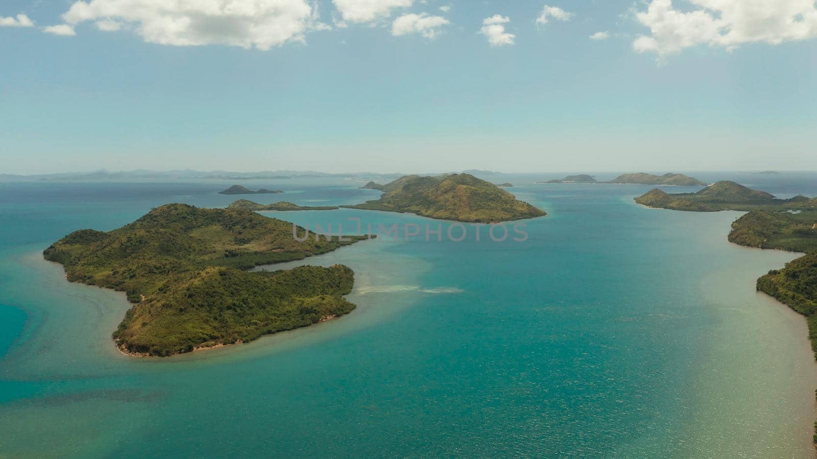 aerial view small island group in province of Palawan. Busuanga, Philippines. Seascape, islands covered with forest, sea with blue water. tropical landscape, travel concept