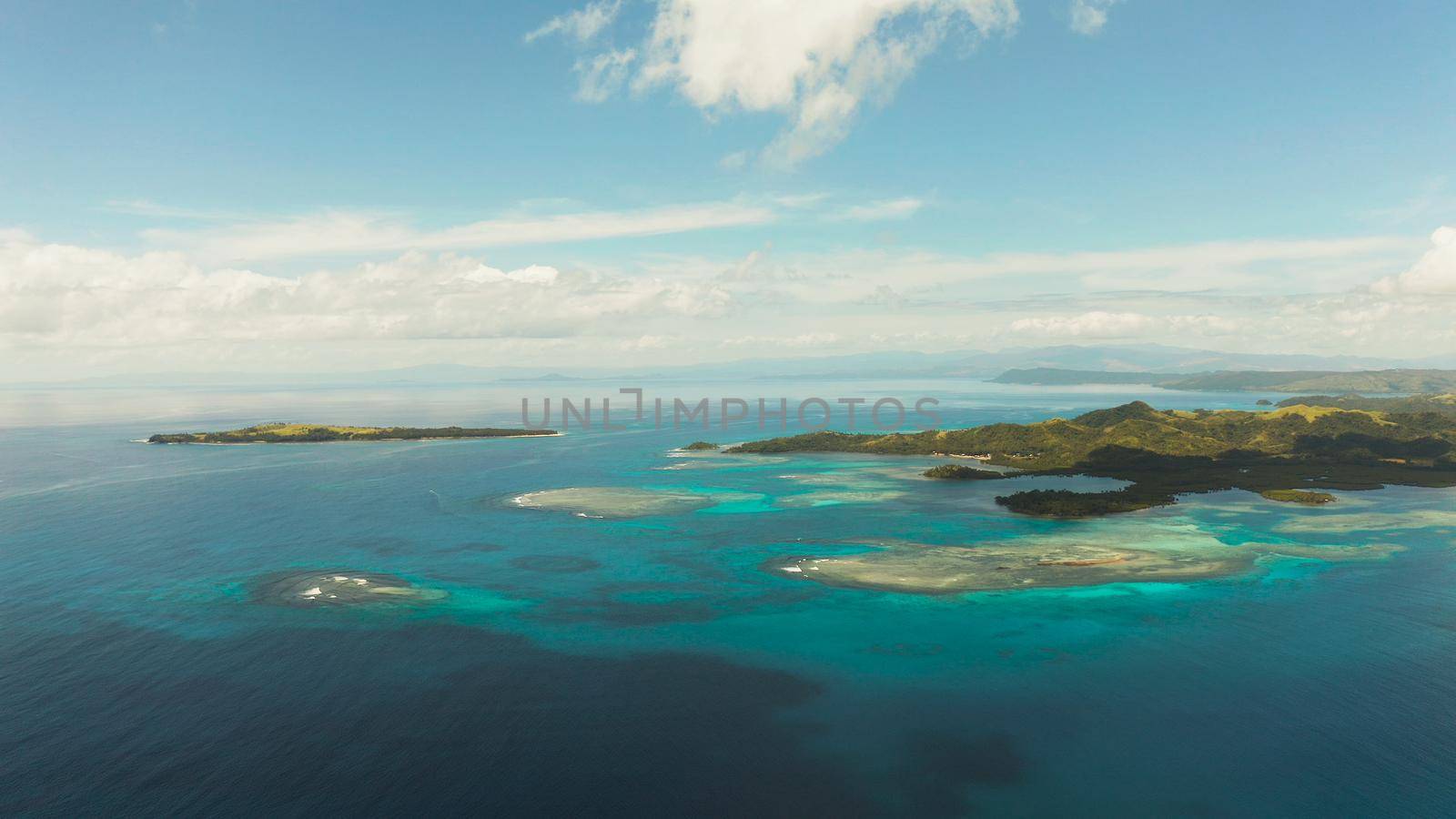Seascape: Tropical Islands with beaches and azure coral reef water from above. Bucas grande, Philippines. Summer and travel vacation concept.