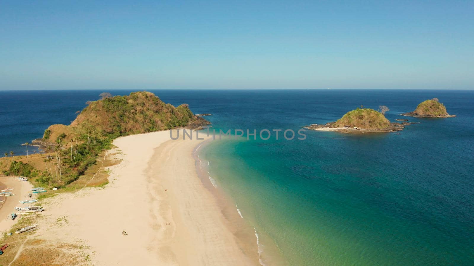 Wide sand beach Nacpan Beach, aerial view. El Nido, Palawan, Philippine Islands. Seascape with tropical beach and islands. Summer and travel vacation concept