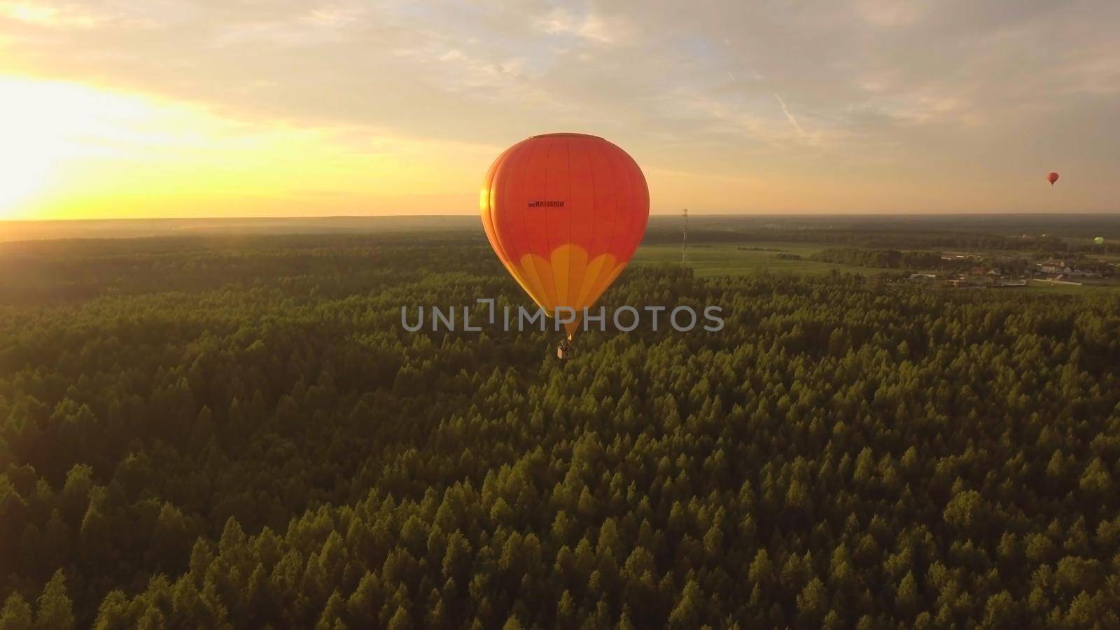 Aerial view Hot air balloon in the sky over a field in the countryside in the beautiful sky and sunset. Balloon silhouette with sunrise, Aerostat fly in the countryside.