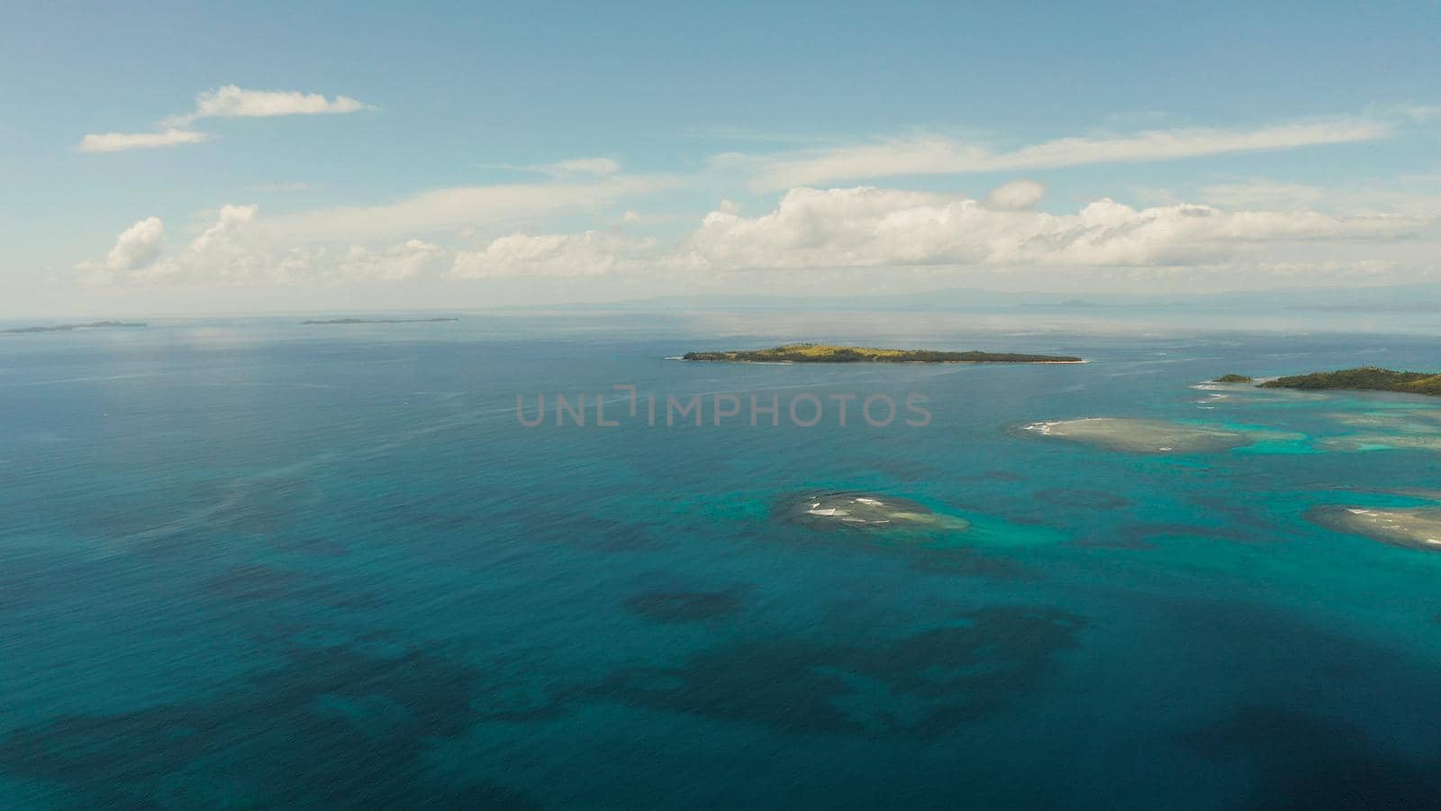 Tropical islands in turquoise lagoon and coral reef water, aerial view. Bucas grande, Philippines. Summer and travel vacation concept.