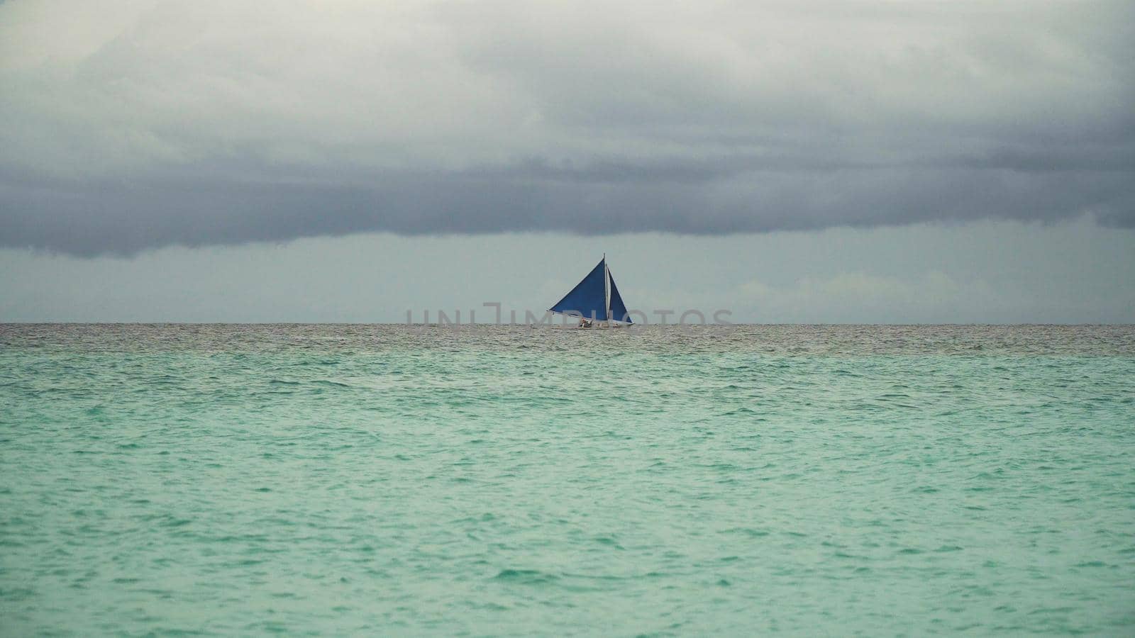 Sailing boat on sea. Sailing ship yachts with blue sails in the ocean. Sailing ship yachts in the sea. Philippines, Boracay. Travel concept.
