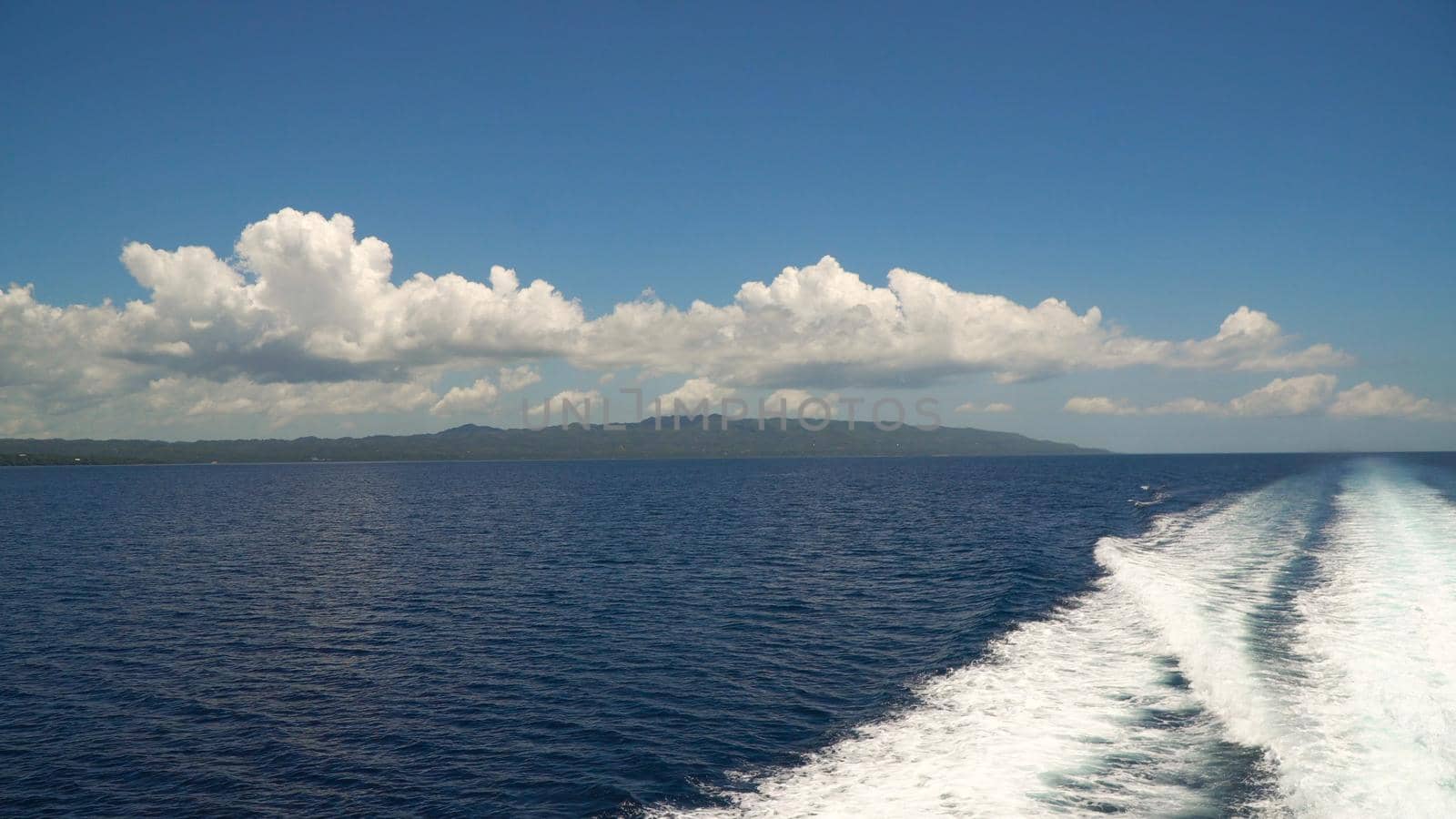 Water trace formed from powerful speed ferry engines, cruising at high speed. Trail on sea surface behind of speed boats. Water trail foaming behind a ferry. Travel concept.