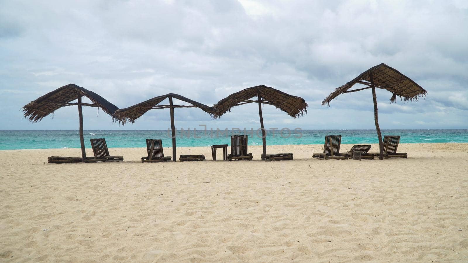 Beach with deck chairs, sun beds, umbrellas.Beach, sea, sand,wave. Seascape ocean and beautiful beach paradise, blue sky, clouds. Philippines Travel concept