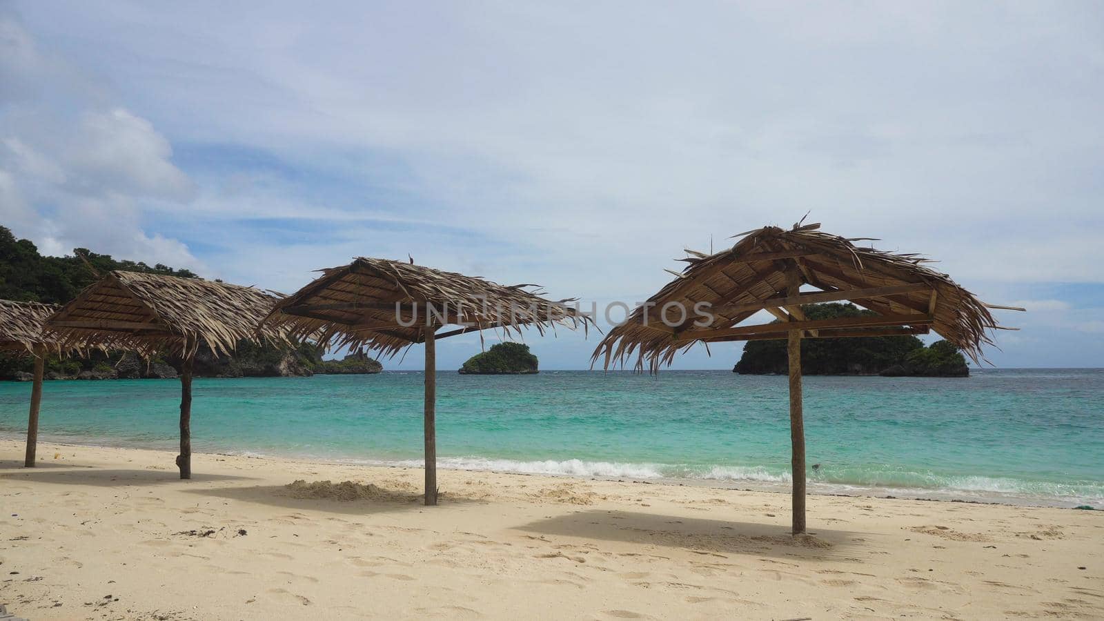 Beach with deck chairs, sun beds, umbrellas.Beach, sea, sand,wave. Seascape ocean and beautiful beach paradise, blue sky, clouds. Philippines Travel concept