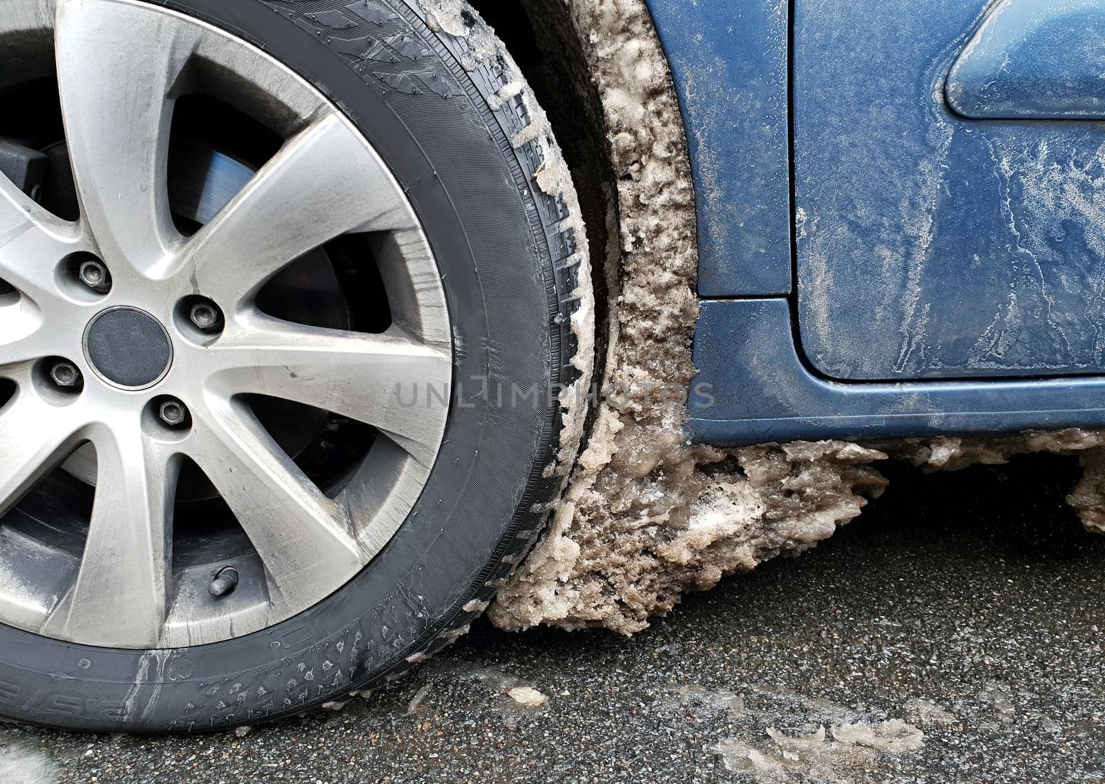 Frozen ice in the wheel arch of a car. by hamik