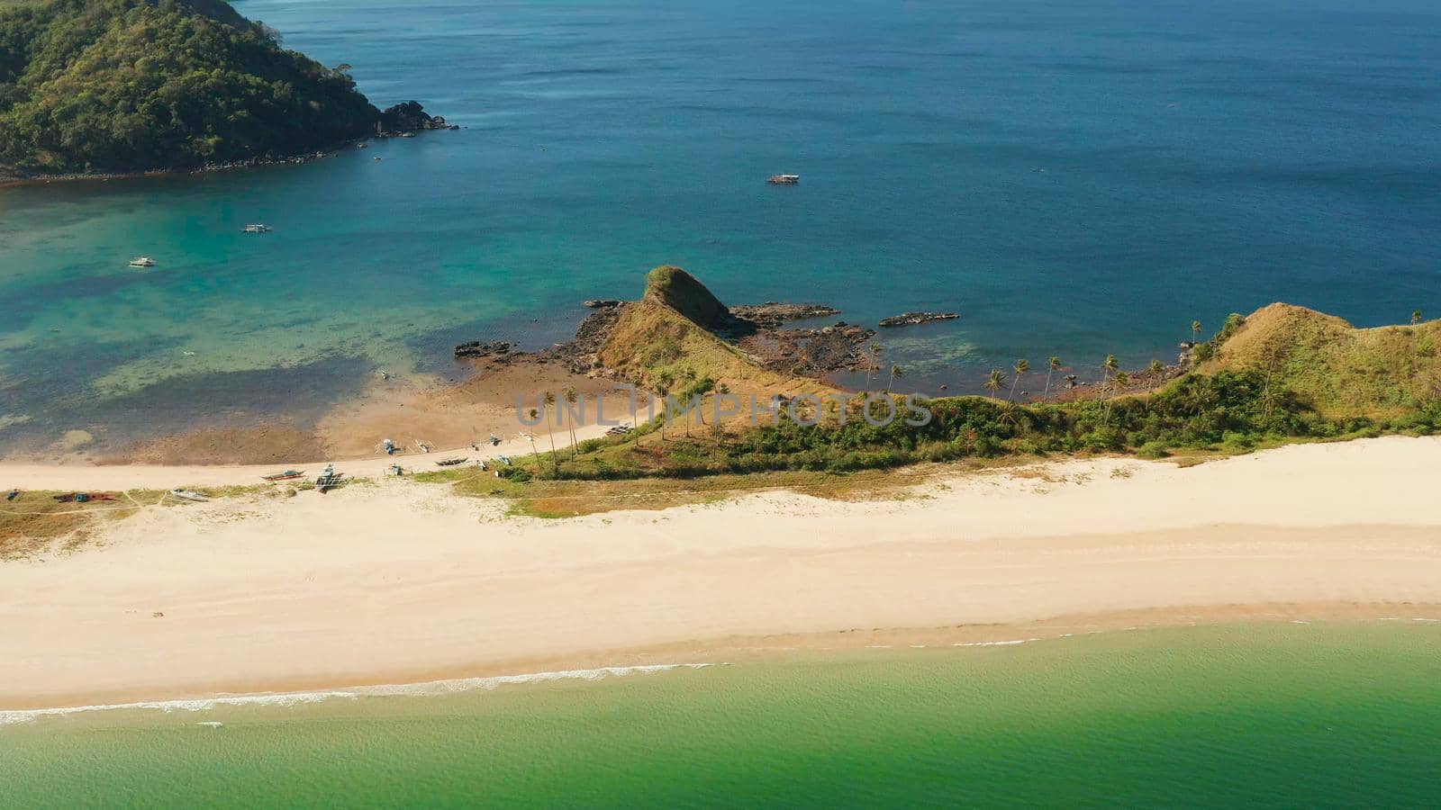 Wide sand beach Nacpan Beach, aerial view. El Nido, Palawan, Philippine Islands. Seascape with tropical beach and islands. Summer and travel vacation concept