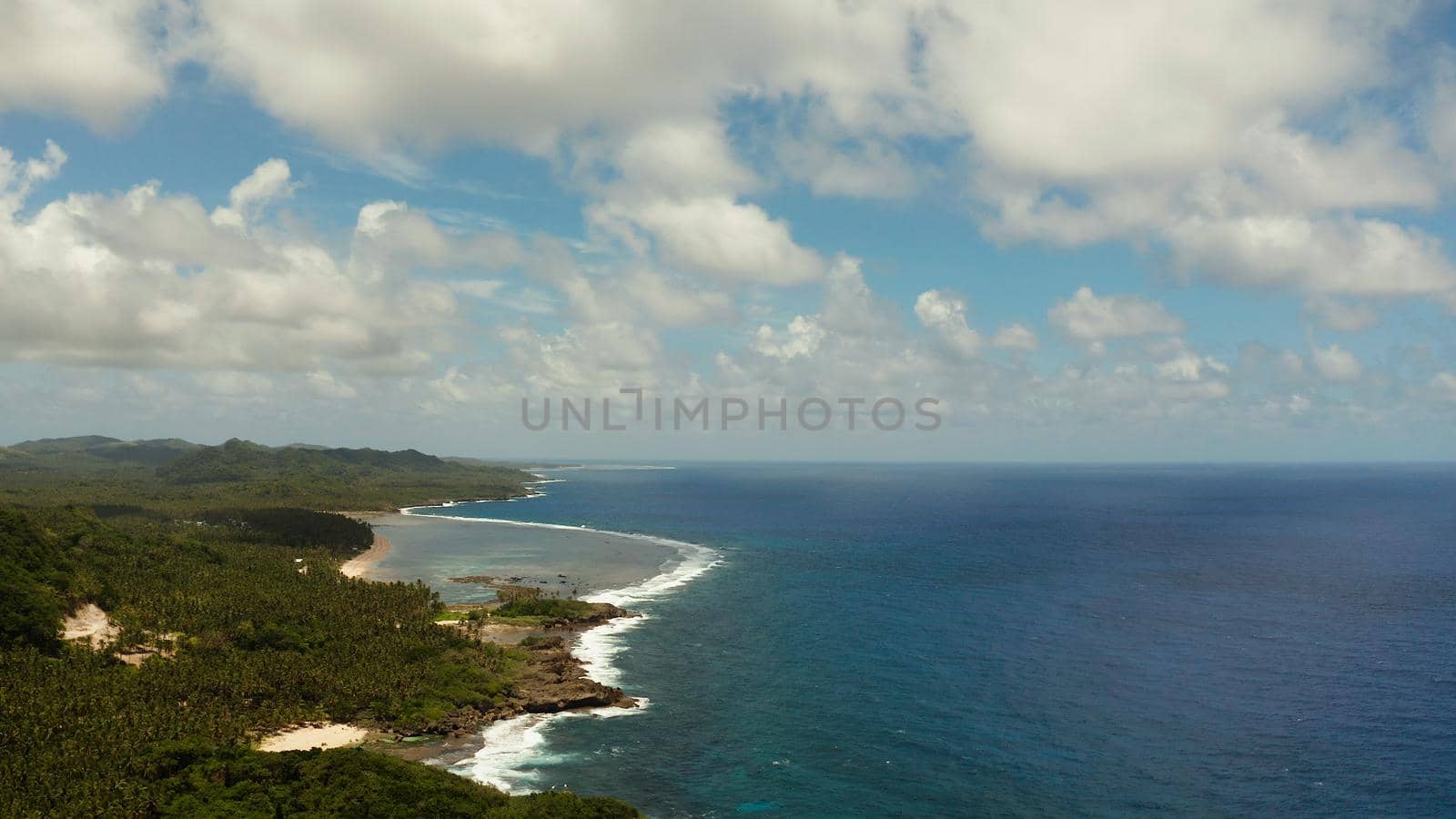 Tropical island with forest and ocean with surf and coral reef top view. Summer and travel vacation concept
