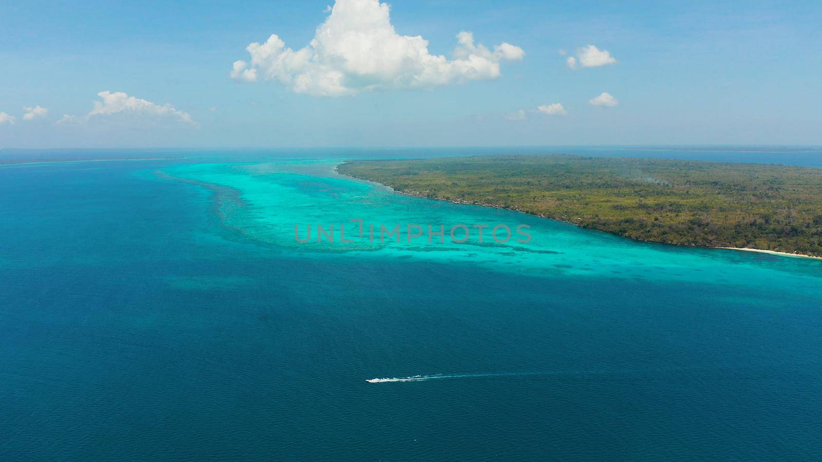 Seascape: Tropical islands with coral reefs in the blue water of the sea, top view. Balabac, Palawan, Philippines. Summer and travel vacation concept.