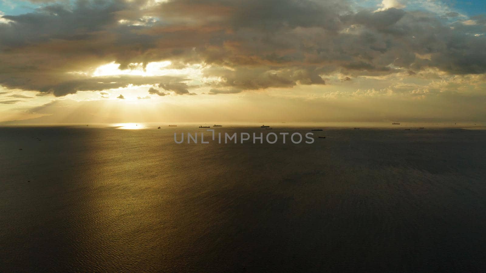 Dramatic sunset over Manila Bay with ships and cargo ships, top view. Summer and travel vacation concept