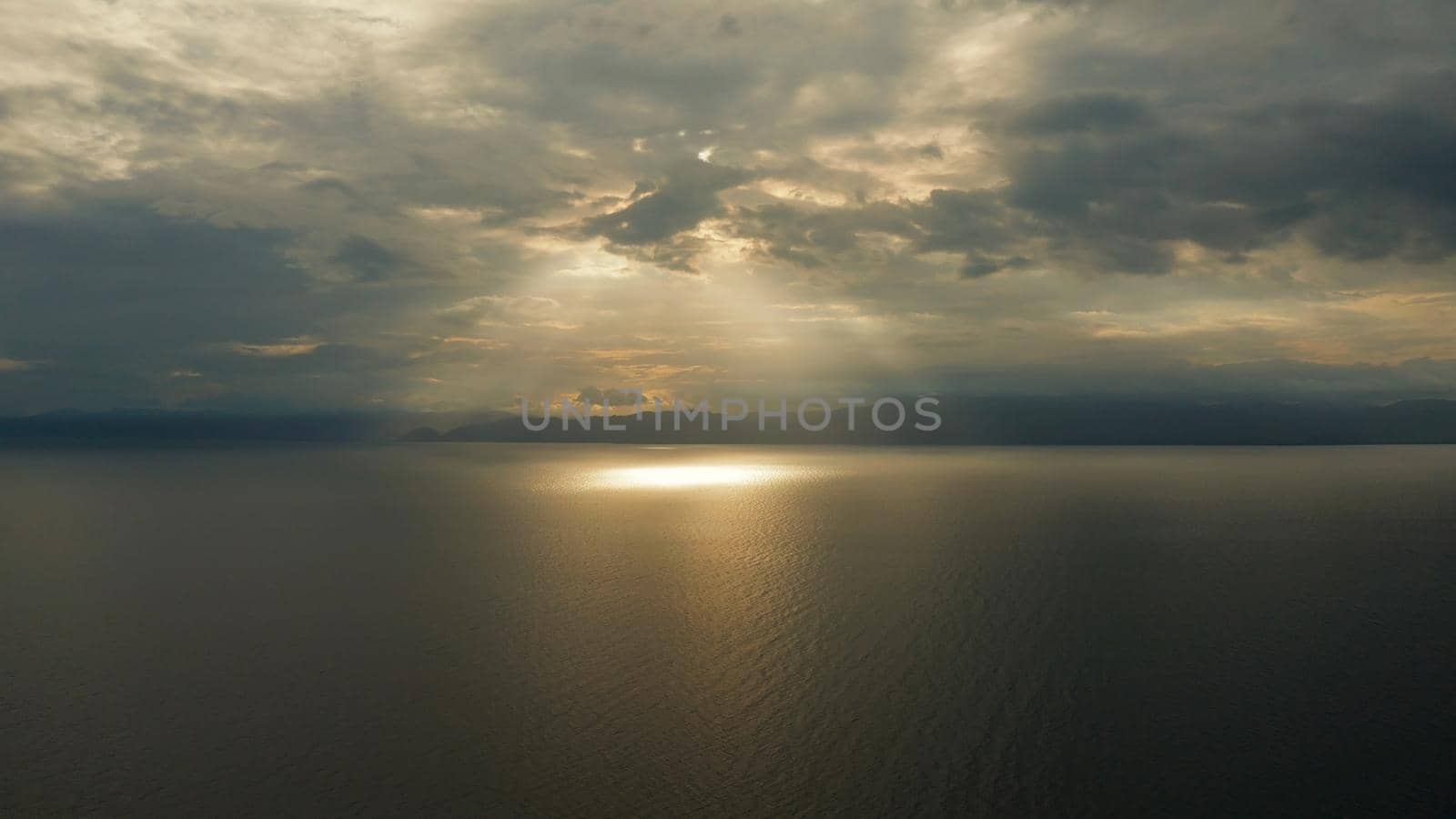 Colorful bright clouds during sunset over the sea, aerial view. Sunset over ocean. Seascape, Summer and travel vacation concept, Moalboal, Philippines.