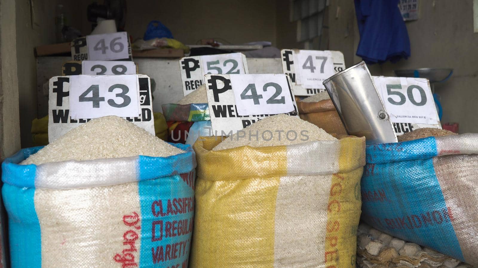 Rice for sale at the asian market. Various bags of rice in a local outdoor market with price. Philippines.