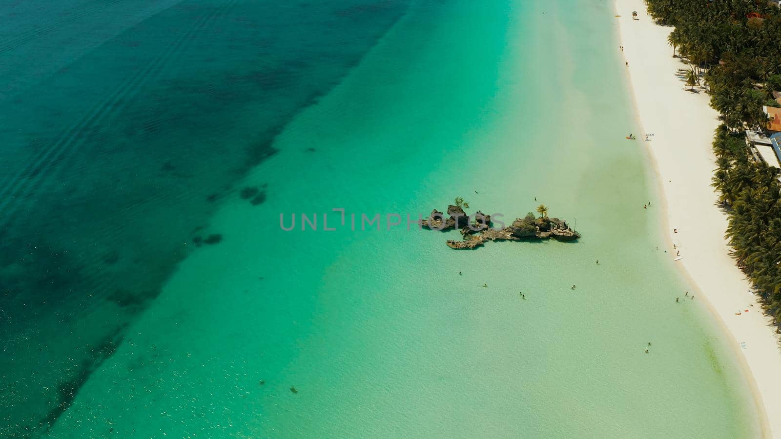 Travel concept: sandy tropical beach with hotels and tourists near the blue lagoon, aerial view, Boracay, Philippines. Seascape with beach on tropical island. Summer and travel vacation concept.