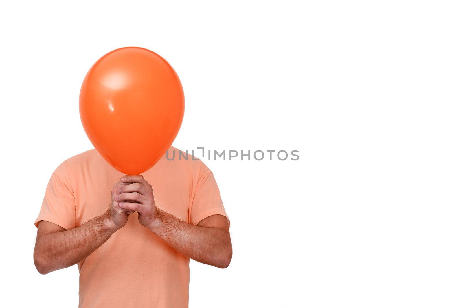 A man holds a balloon in front of his head. The balloon is like a mask. Isolated on a white background. copy space
