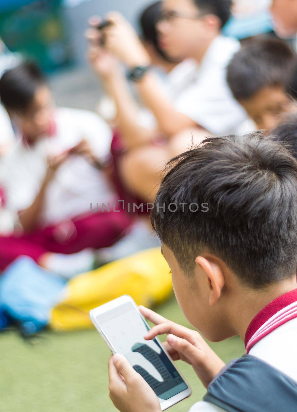 BANGKOK THAILAND - April 19,2018 Many student playing with smartphone during the brake time in school by Satakorn