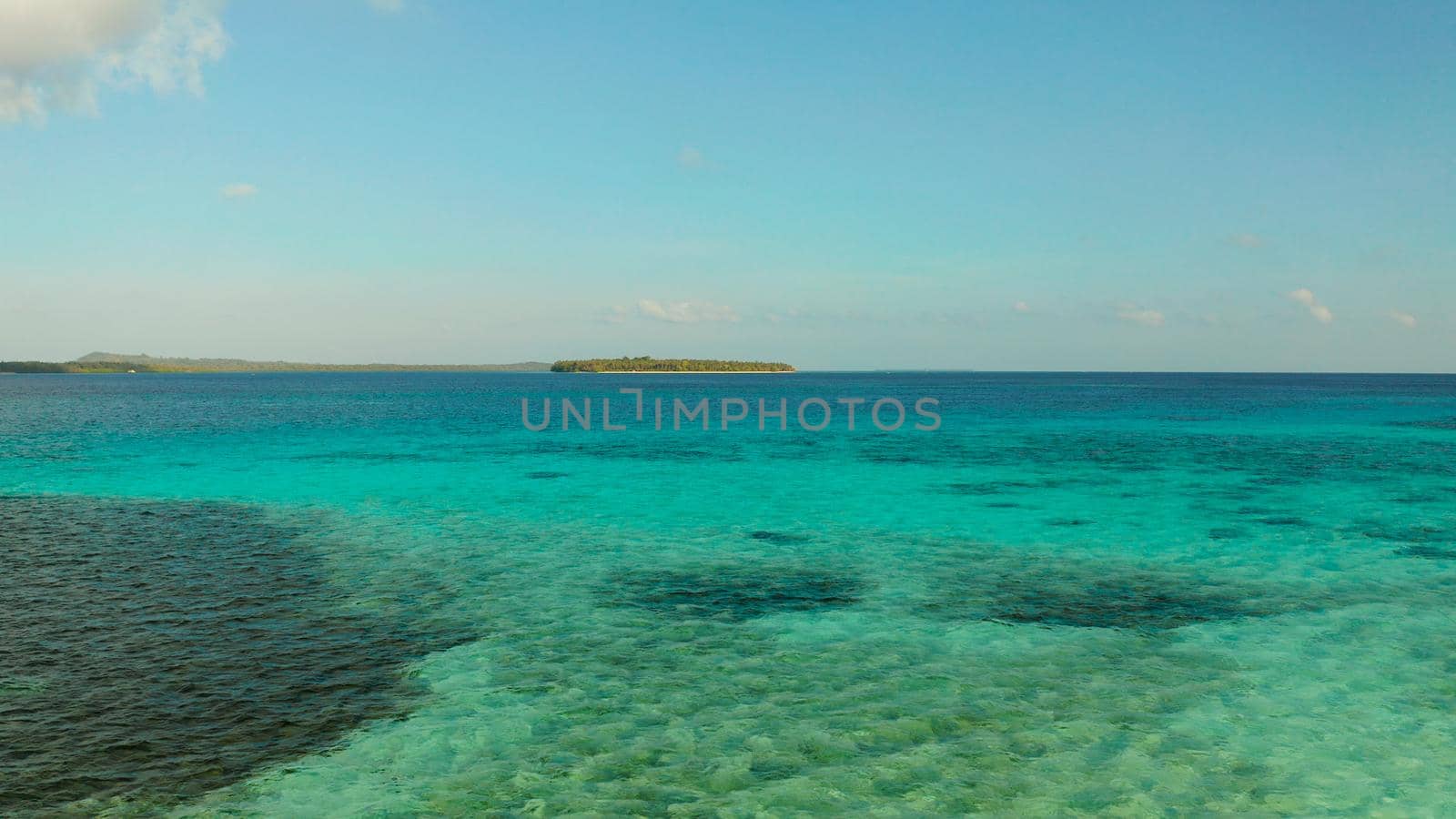 Sea water surface in lagoon with tropical islands copy space for text. Summer and travel vacation concept.