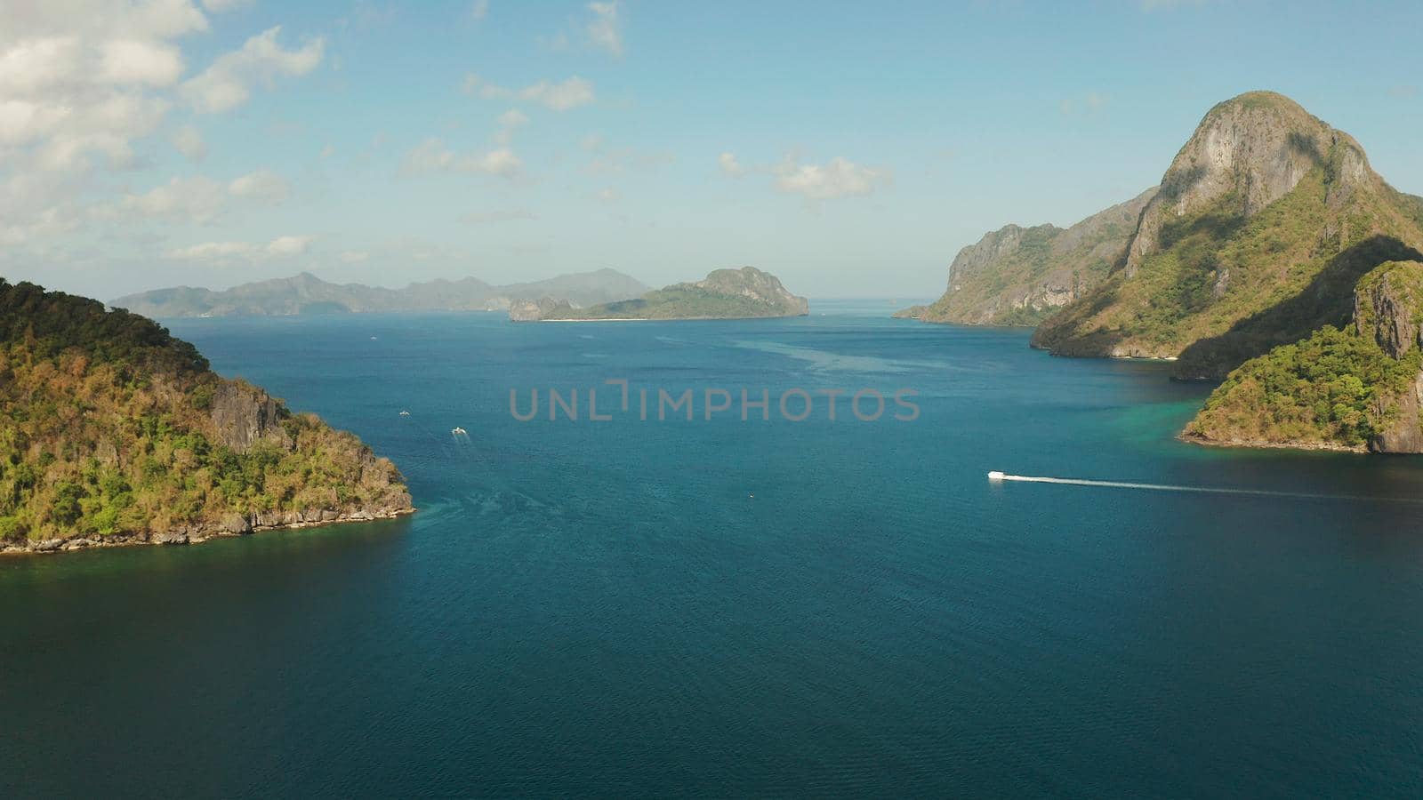Cove with tropical rocky islands covered with rainforest, sea with blue water, aerial view. El nido, Philippines, Palawan. Tropical Mountain Range